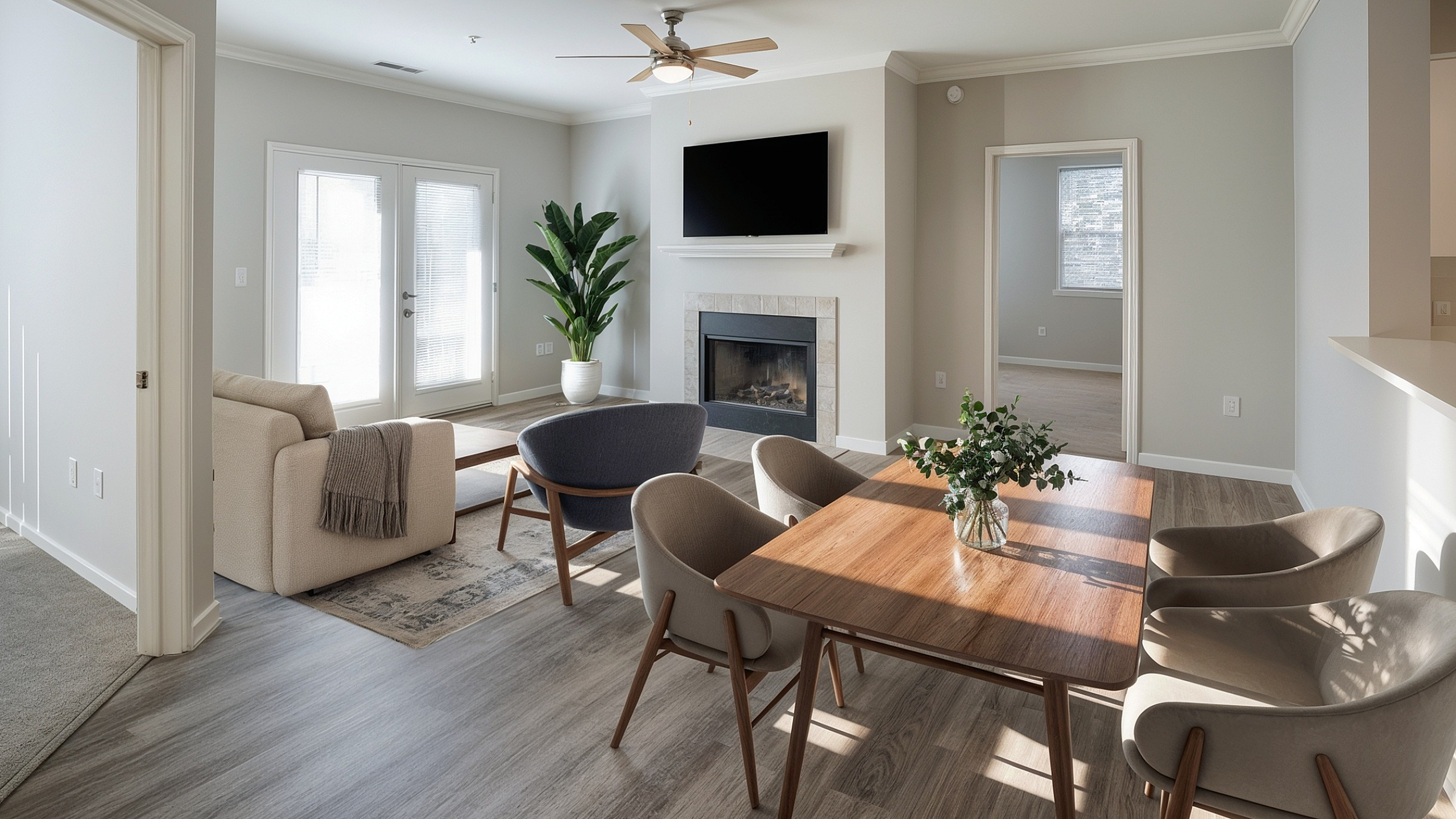 Elegant open-plan living area featuring a cozy fireplace, contemporary dining set, and abundant natural light, perfect for a modern lifestyle.