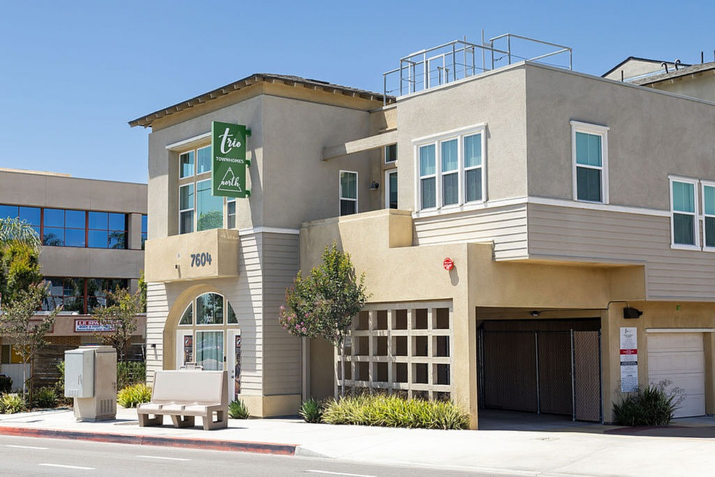 Chic modern townhome exterior with large windows and elegant architectural details, perfect for stylish urban living.