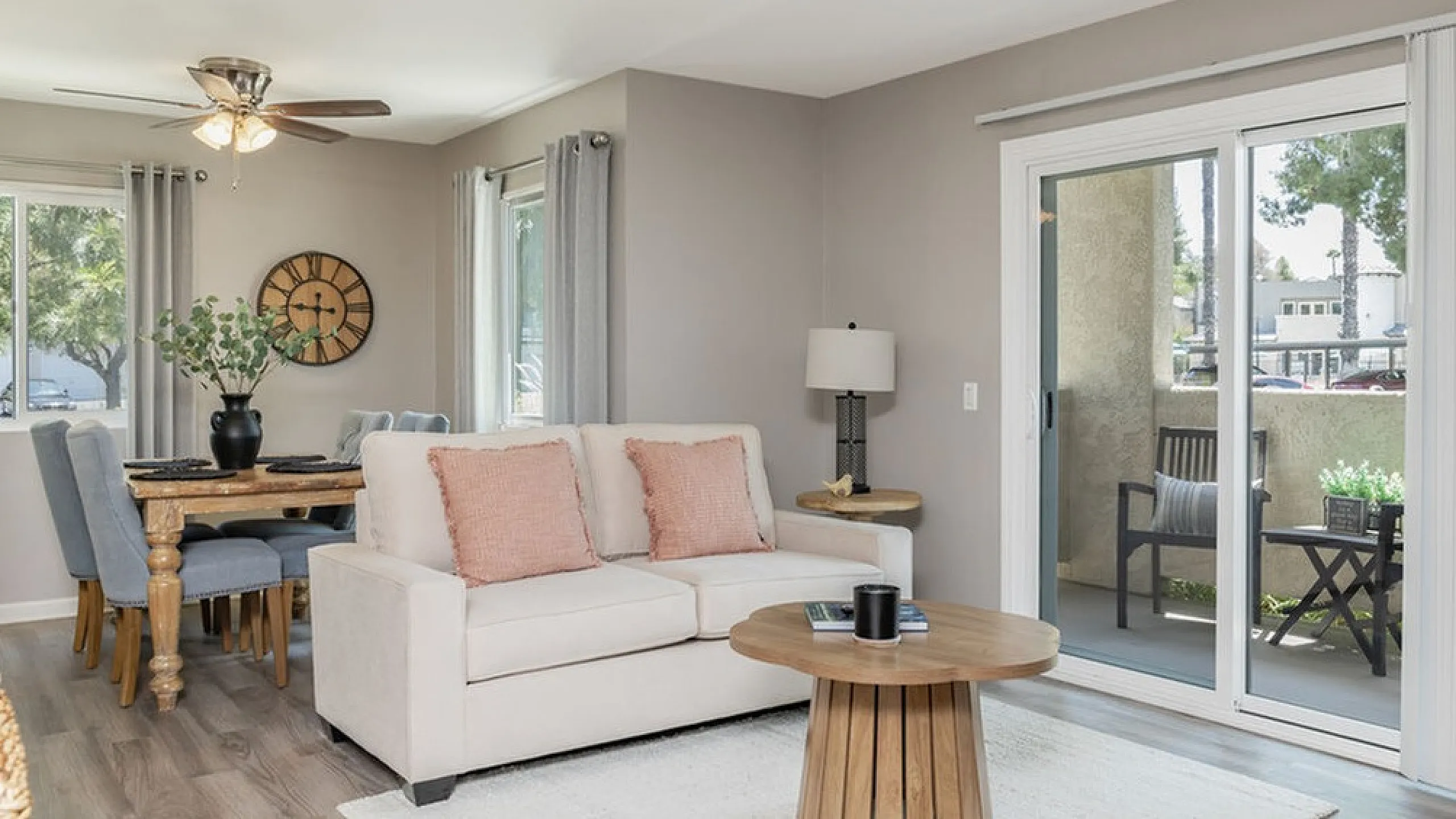 Bright, inviting living area with cozy couch and stylish dining space, leading to a scenic balcony view for ultimate relaxation.
