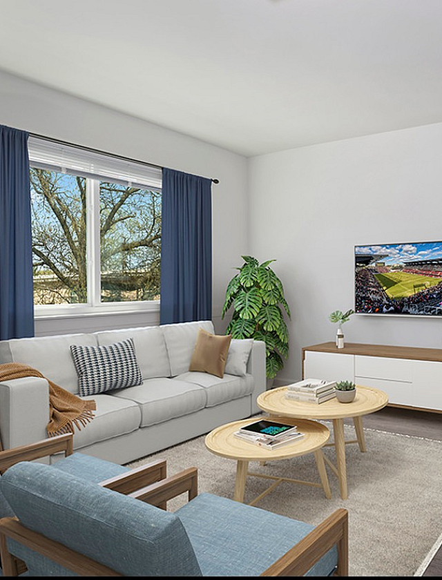 Inviting living room with modern decor, featuring a cozy sofa, sleek coffee table, flat-screen TV, and large window with blue curtains.