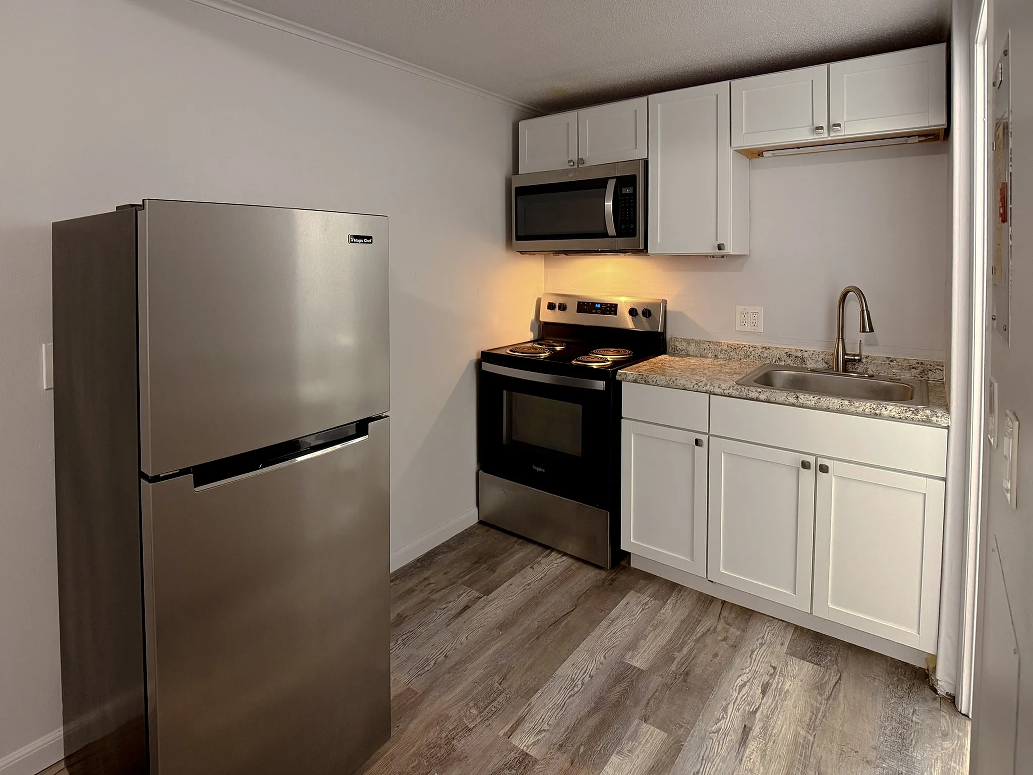 Modern kitchen with sleek stainless steel appliances, elegant cabinetry, and contemporary countertops.