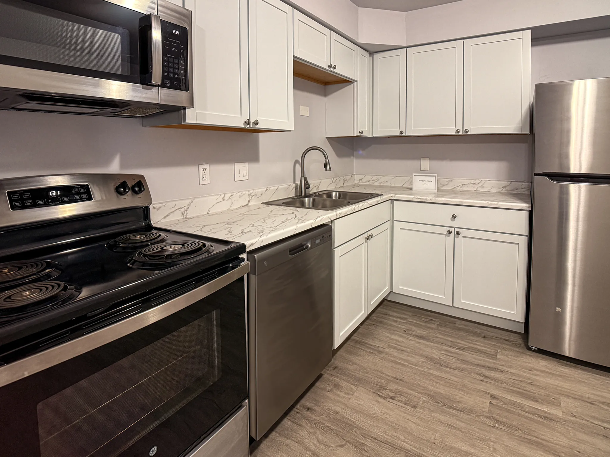 Modern kitchen with sleek stainless steel appliances, elegant marble countertops, and stylish cabinetry.