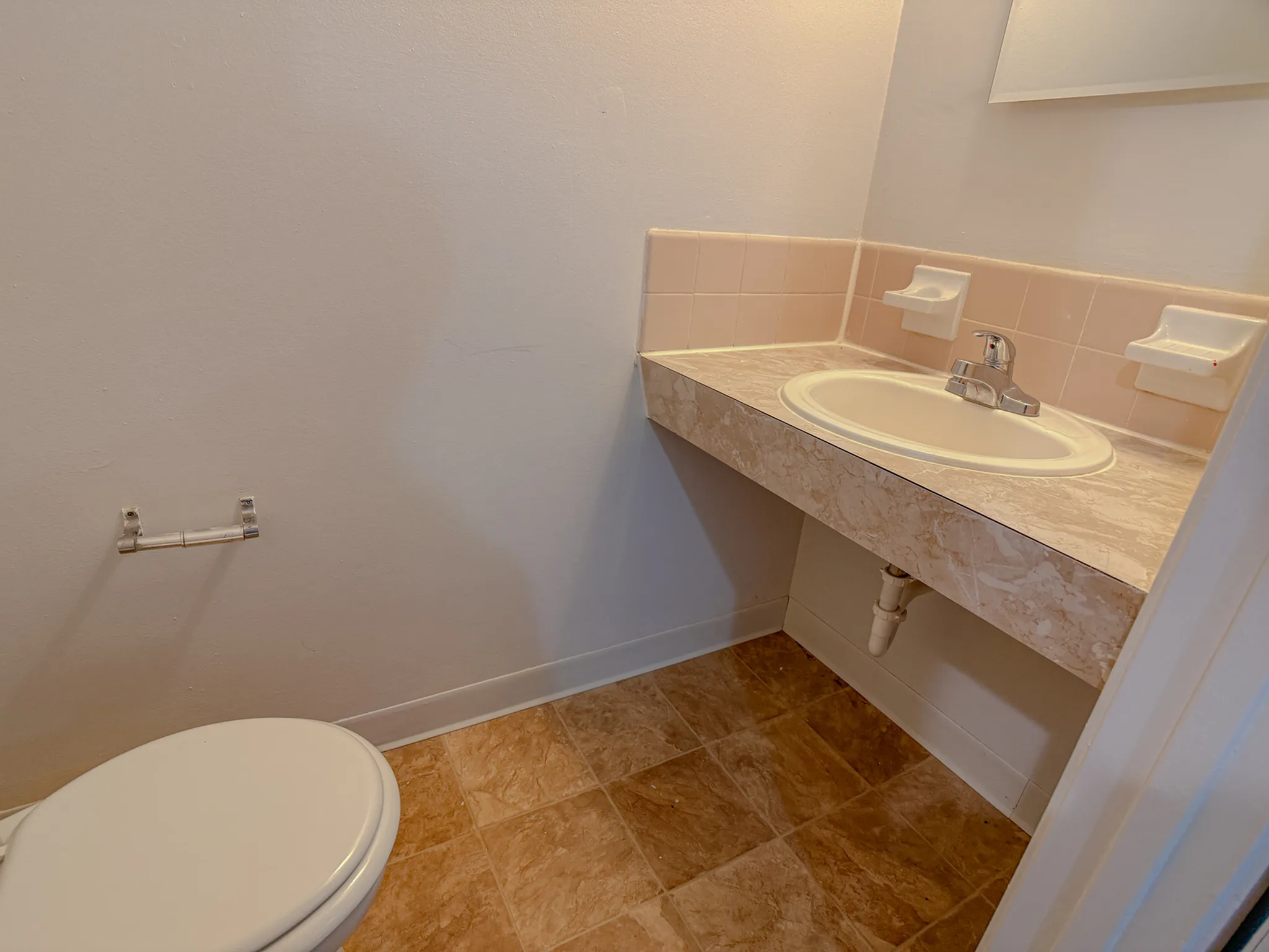 Bright and inviting bathroom with elegant marble countertop and modern fixtures.