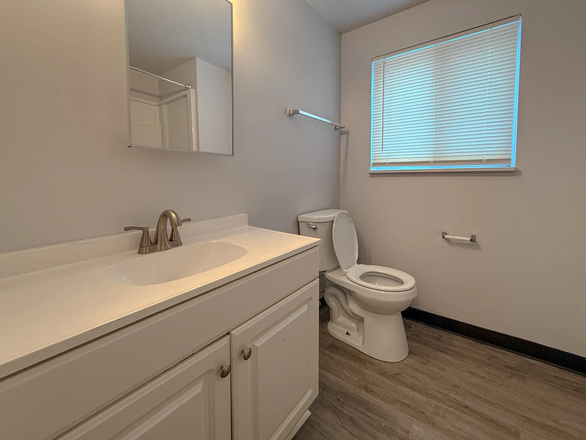 Bright and modern bathroom featuring a sleek vanity with ample storage, contemporary fixtures, and natural light.