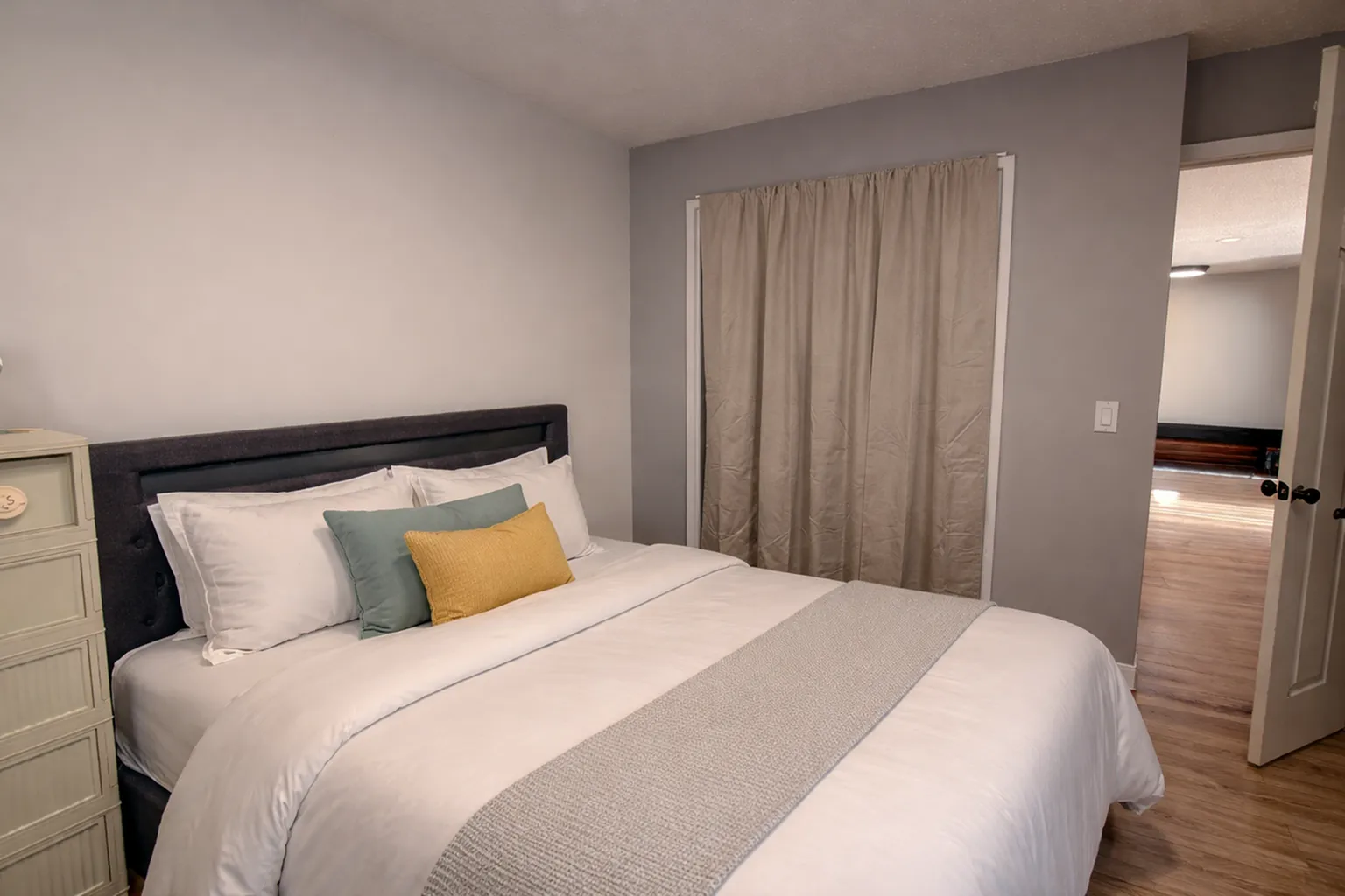 Cozy bedroom with a plush double bed, modern decor, and soft lighting creating a serene ambiance.