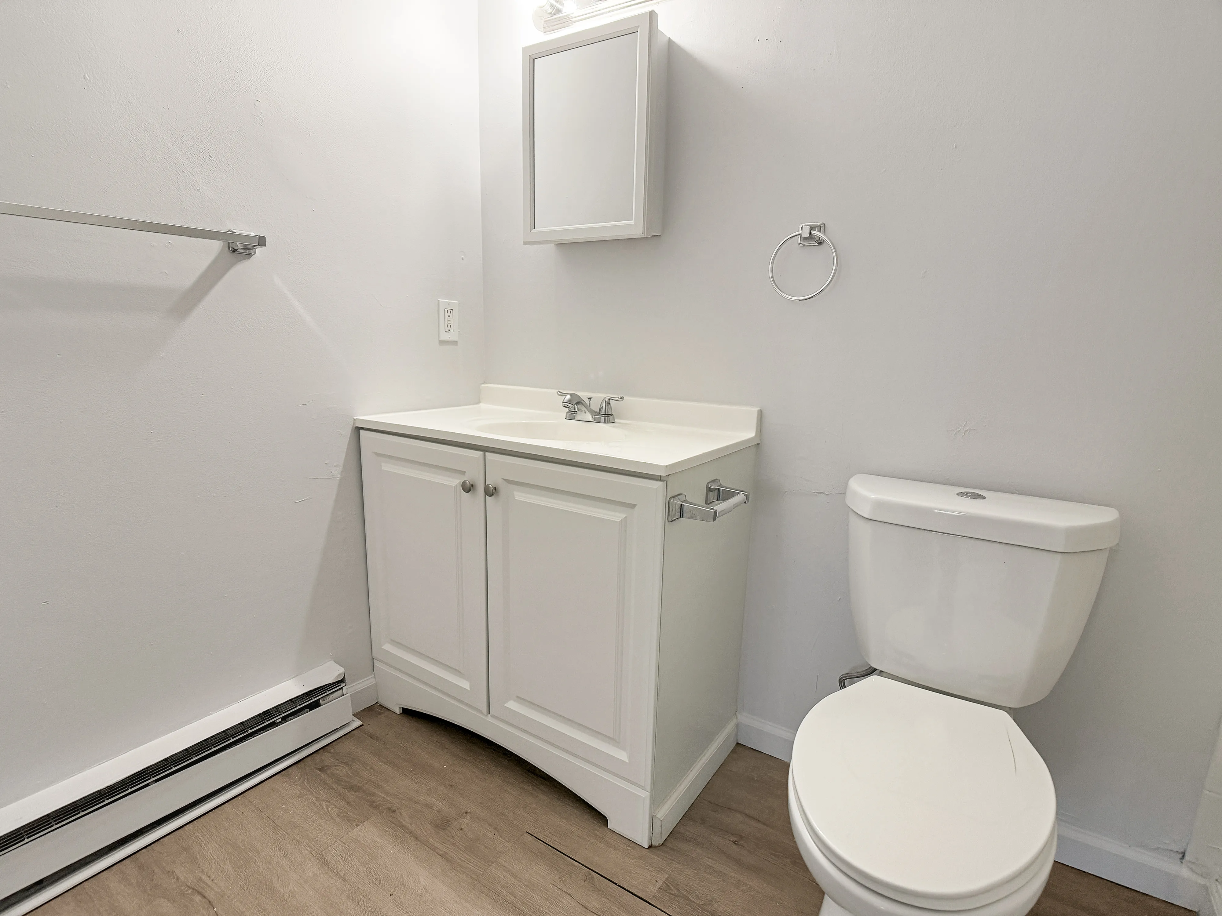 Bright and modern bathroom featuring a sleek white vanity, compact toilet, and contemporary design.