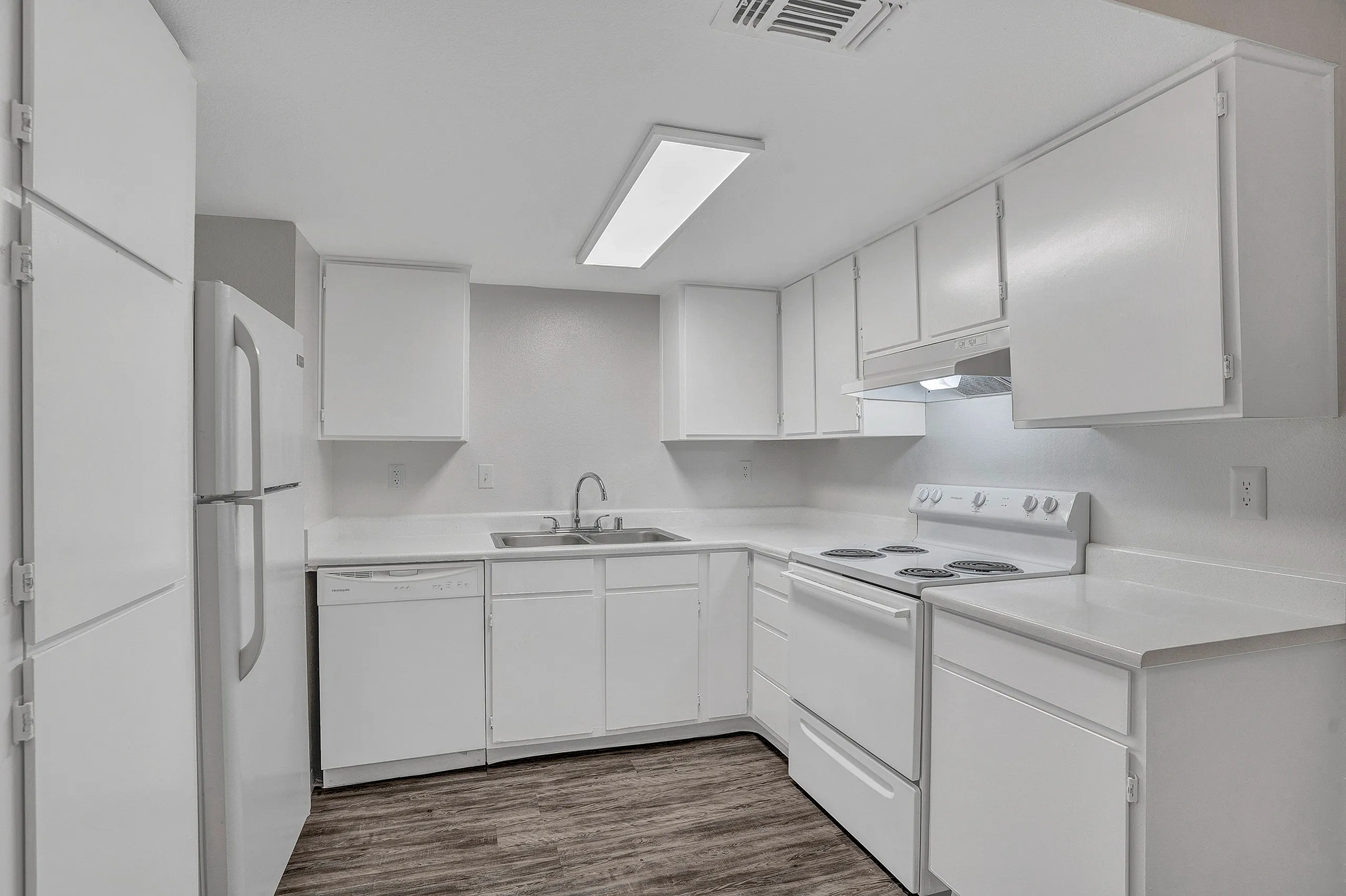 Bright, modern kitchen with sleek white cabinetry, elegant countertops, and stainless steel appliances.