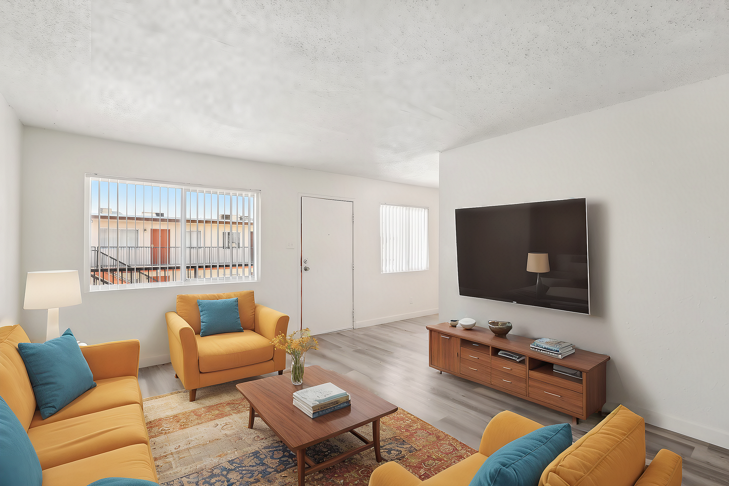 Bright and modern living room with vibrant yellow sofas, stylish decor, and a large wall-mounted TV, perfect for relaxing.