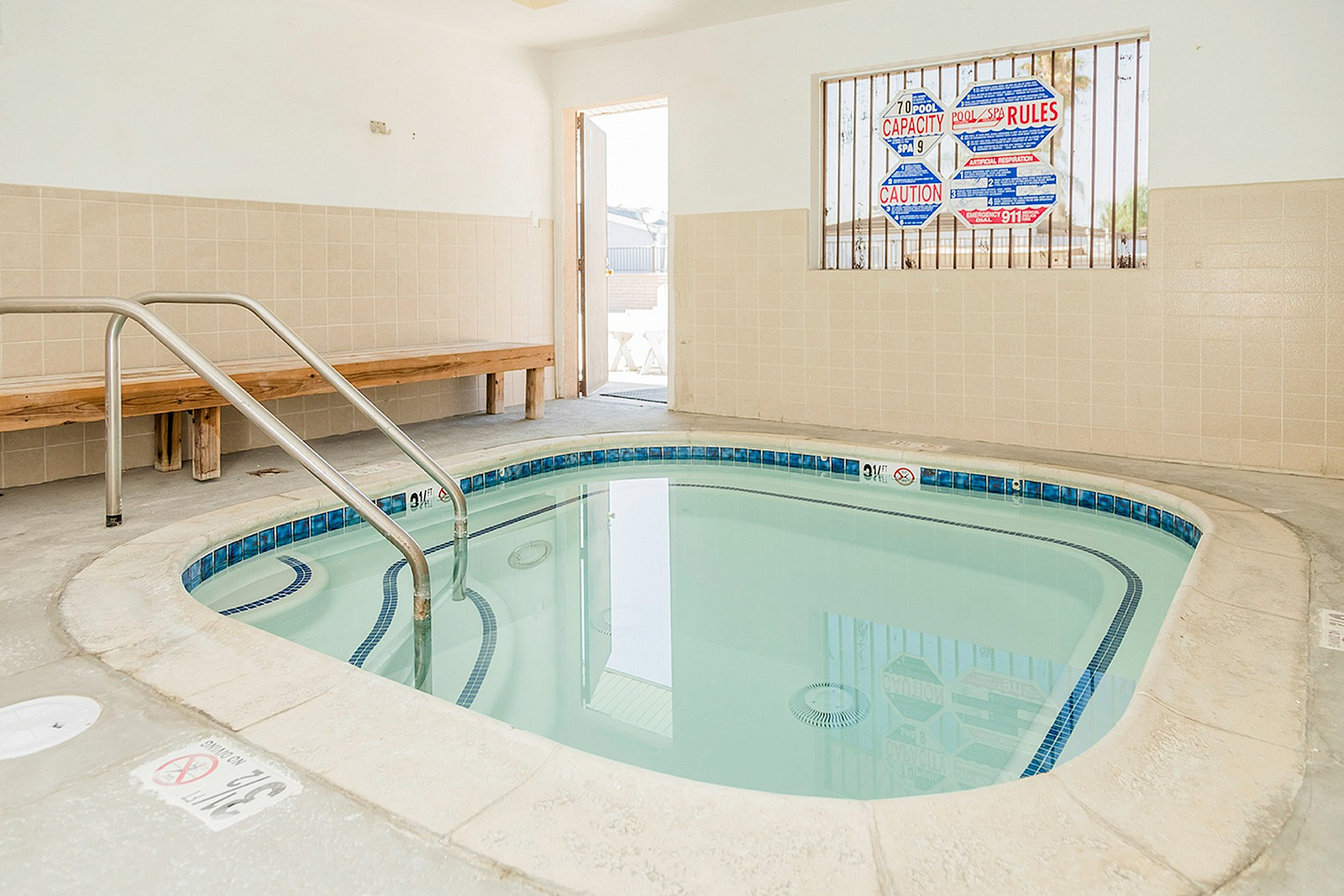 Inviting indoor spa room featuring a clean, cozy hot tub and natural light for ultimate relaxation.