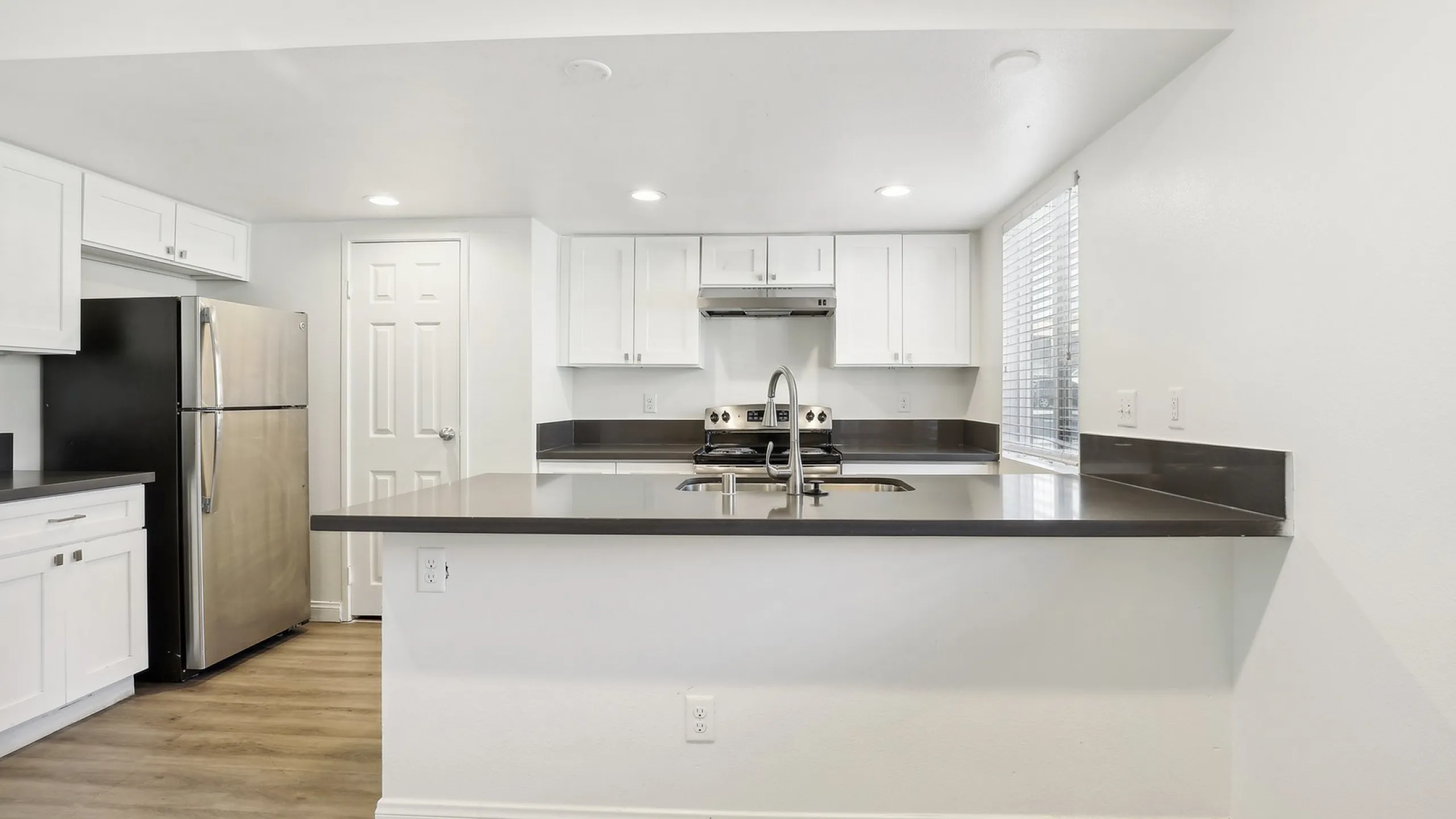 Modern kitchen with sleek stainless steel appliances and a spacious countertop, perfect for home chefs and entertaining.