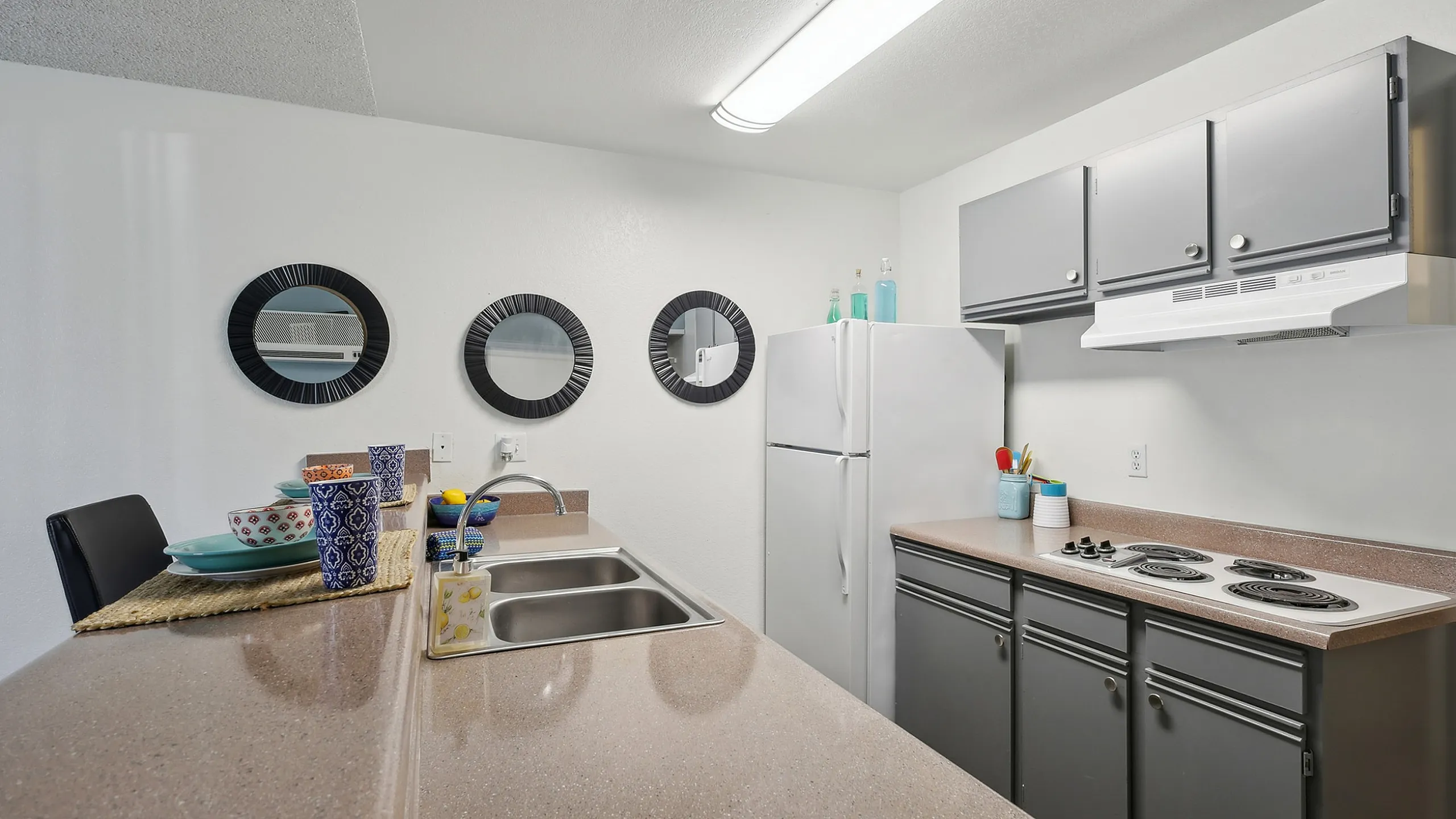 Contemporary kitchen with sleek countertops, modern gray cabinetry, and elegant decor for a stylish culinary experience.