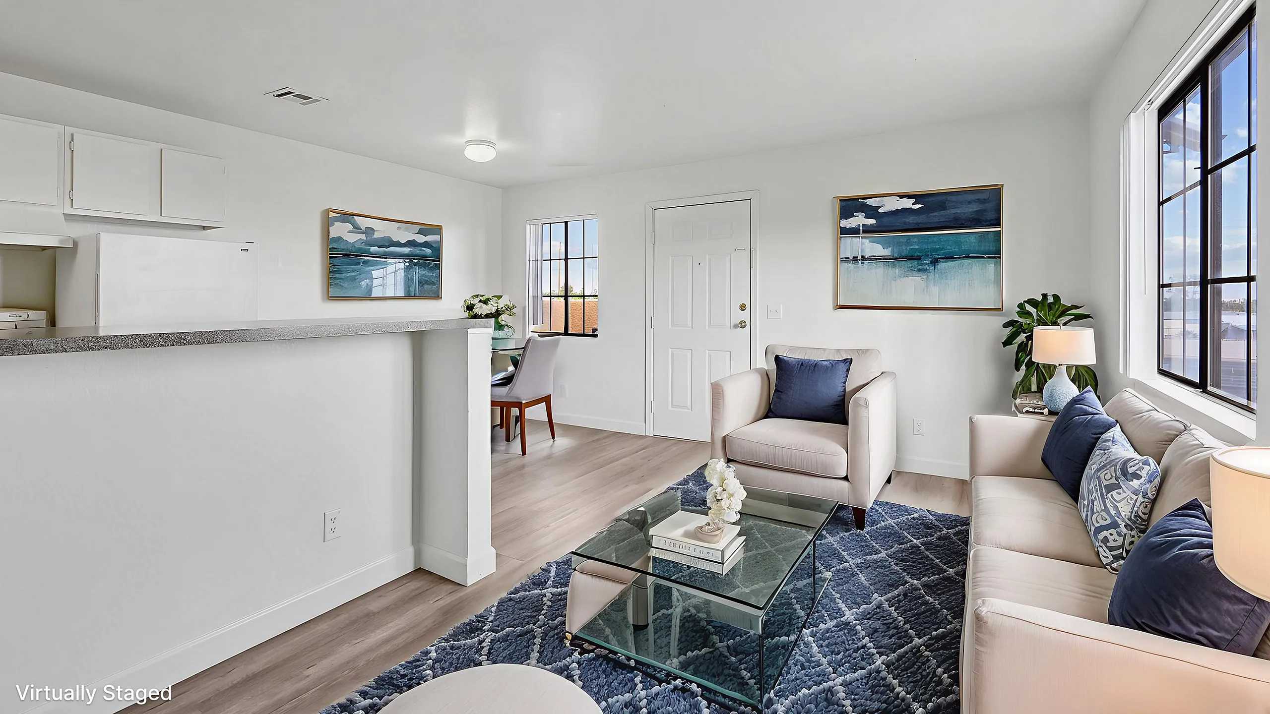Chic and modern living room with elegant decor, plush seating, and large windows offering natural light.