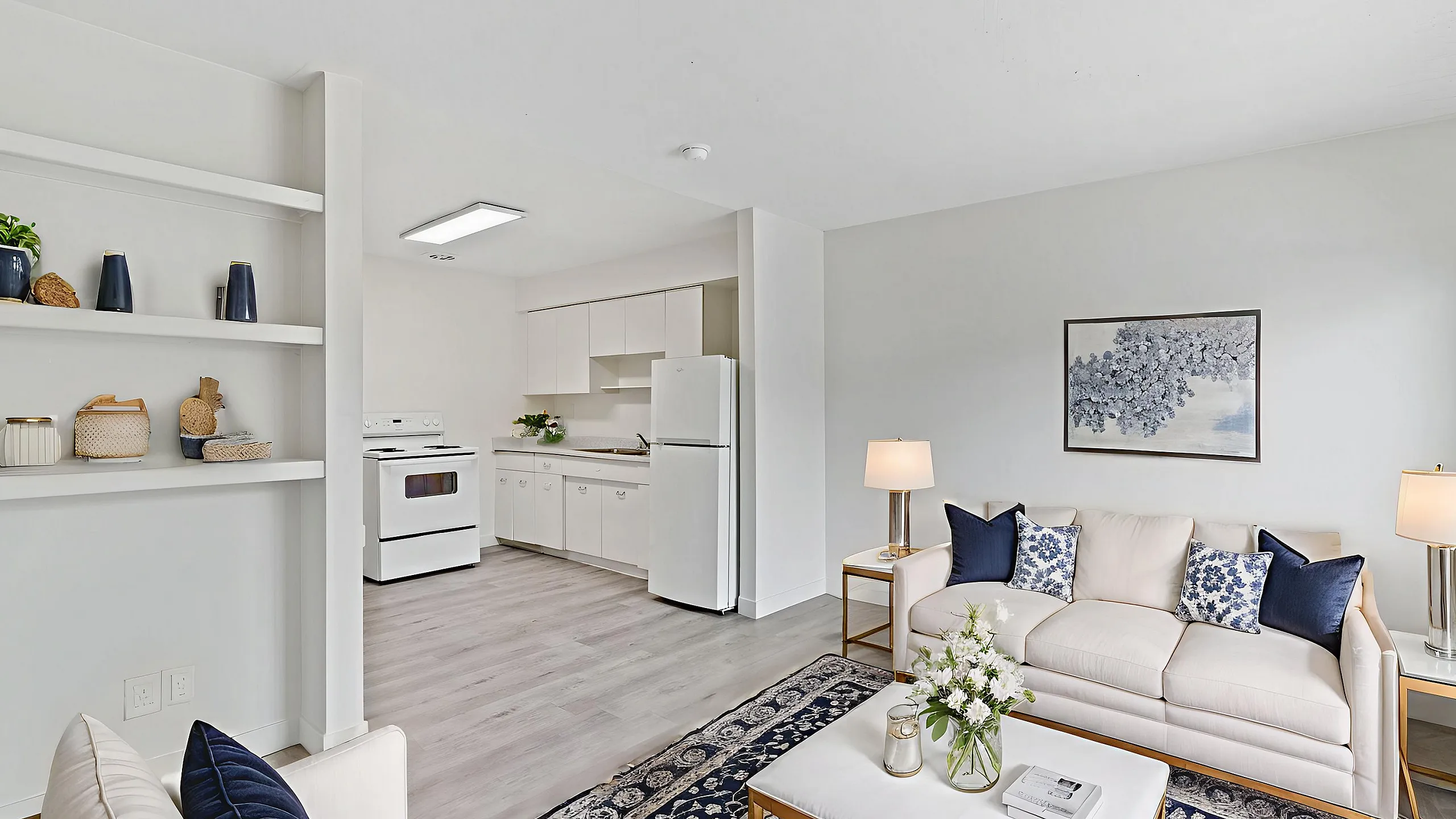 Elegant open-plan living area showcasing a cozy seating arrangement, contemporary decor, and a bright kitchen with modern appliances.