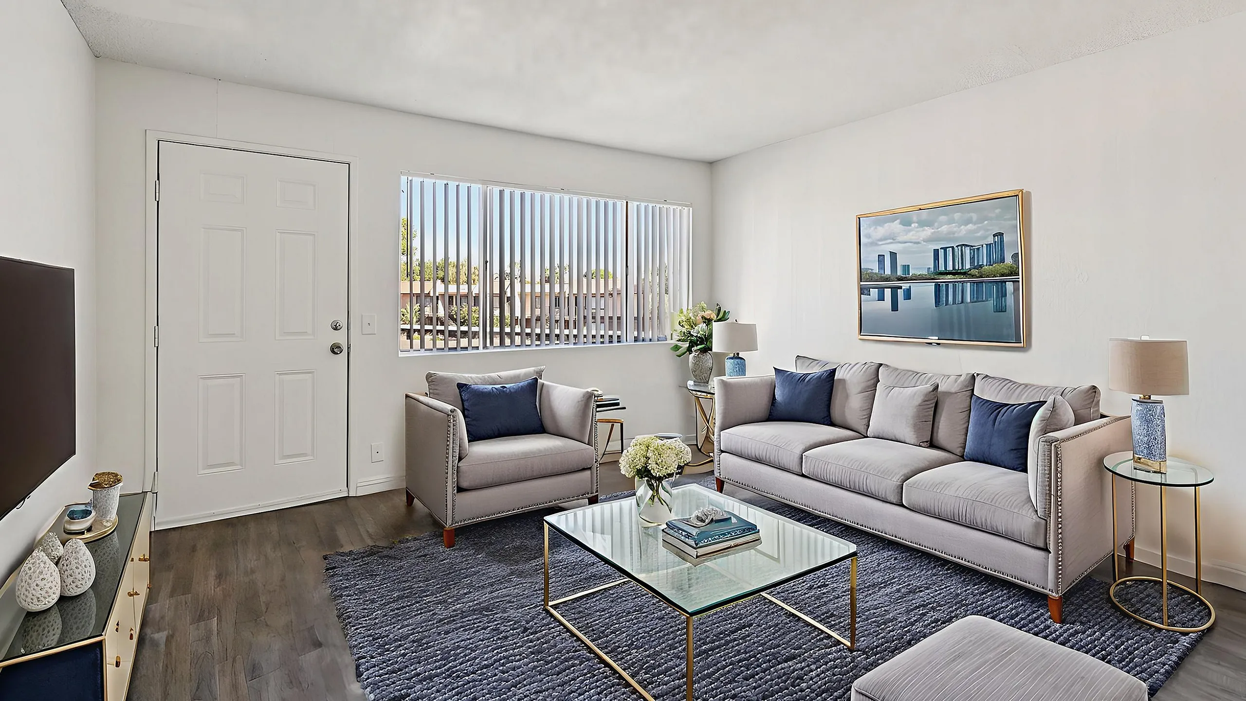 Bright and cozy living room with chic furnishings, featuring a modern sofa, elegant armchair, and decorative accents against a soft color palette.