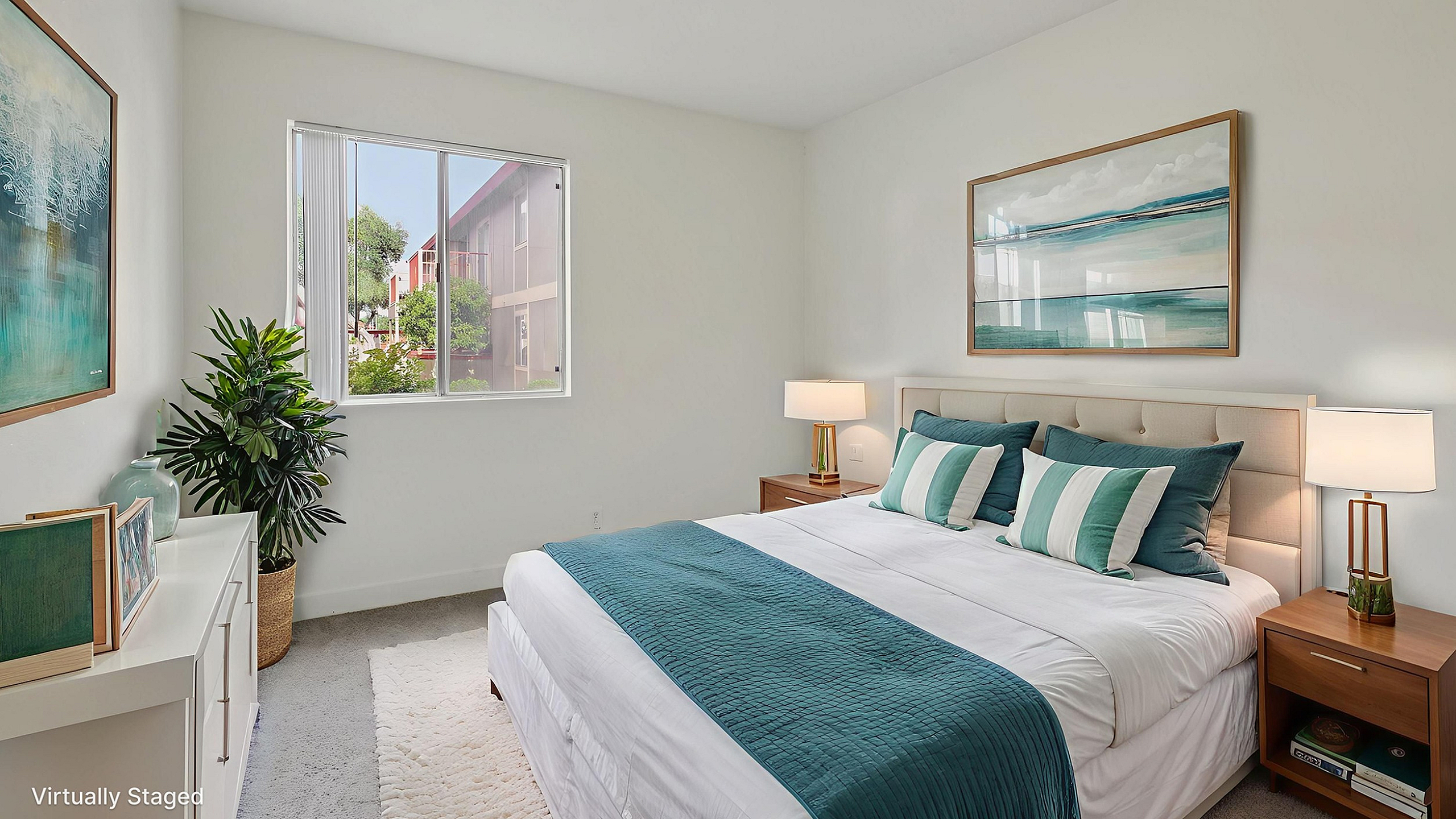 Bright and cozy bedroom with modern decor, featuring a large window with a lush view and elegant artwork on the walls.