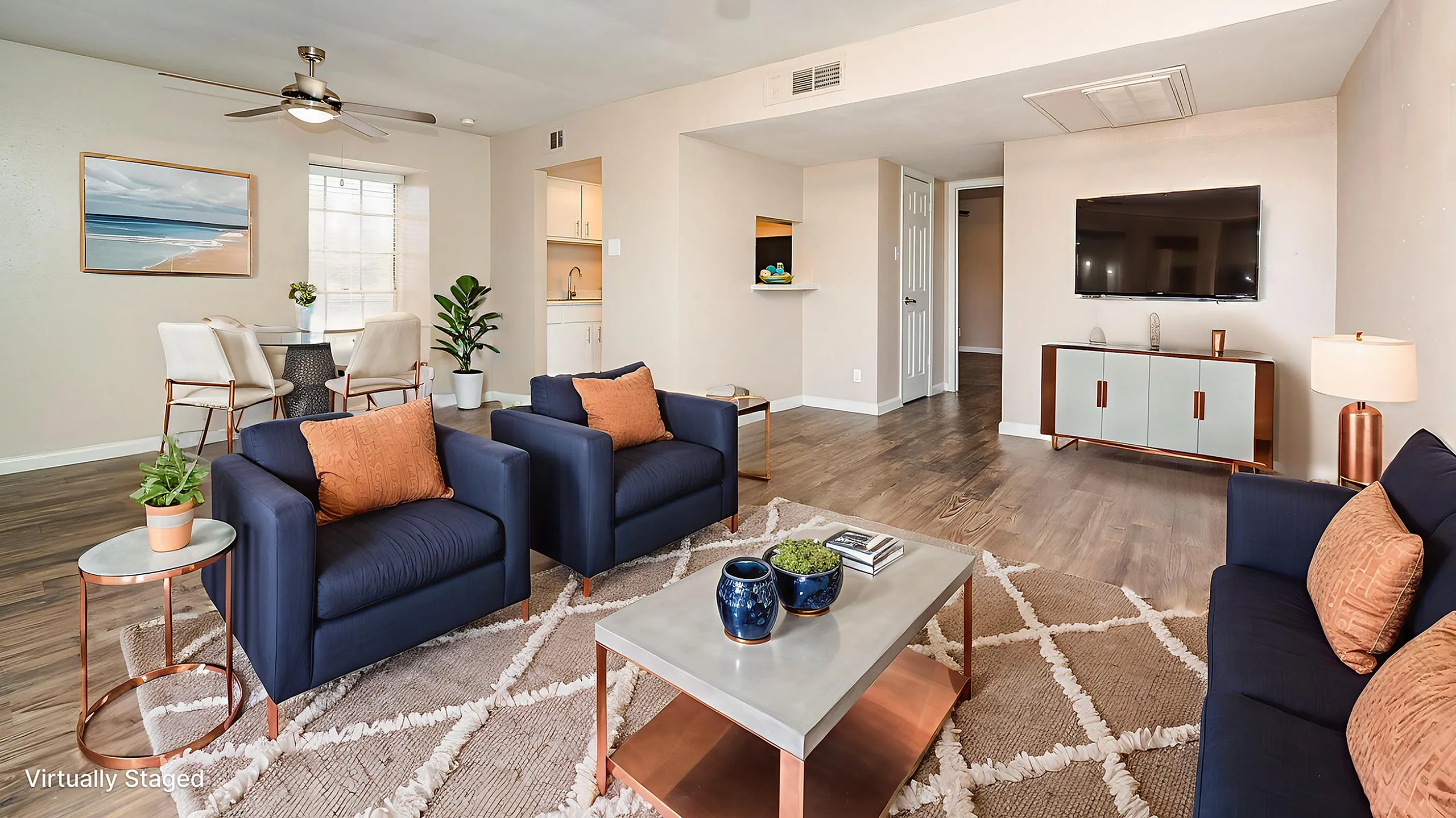 Inviting living room with modern decor, featuring plush navy seating, elegant lighting, and a stylish entertainment setup, perfect for relaxation.