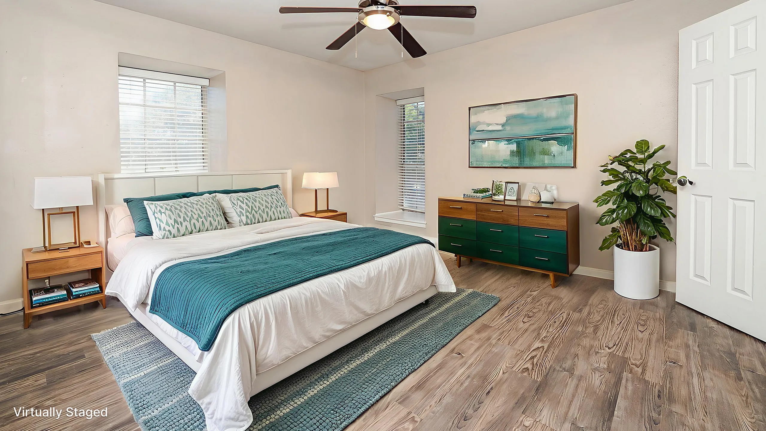 Virtually staged serene bedroom featuring chic decor, modern ceiling fan, and elegant furnishings in tranquil shades.