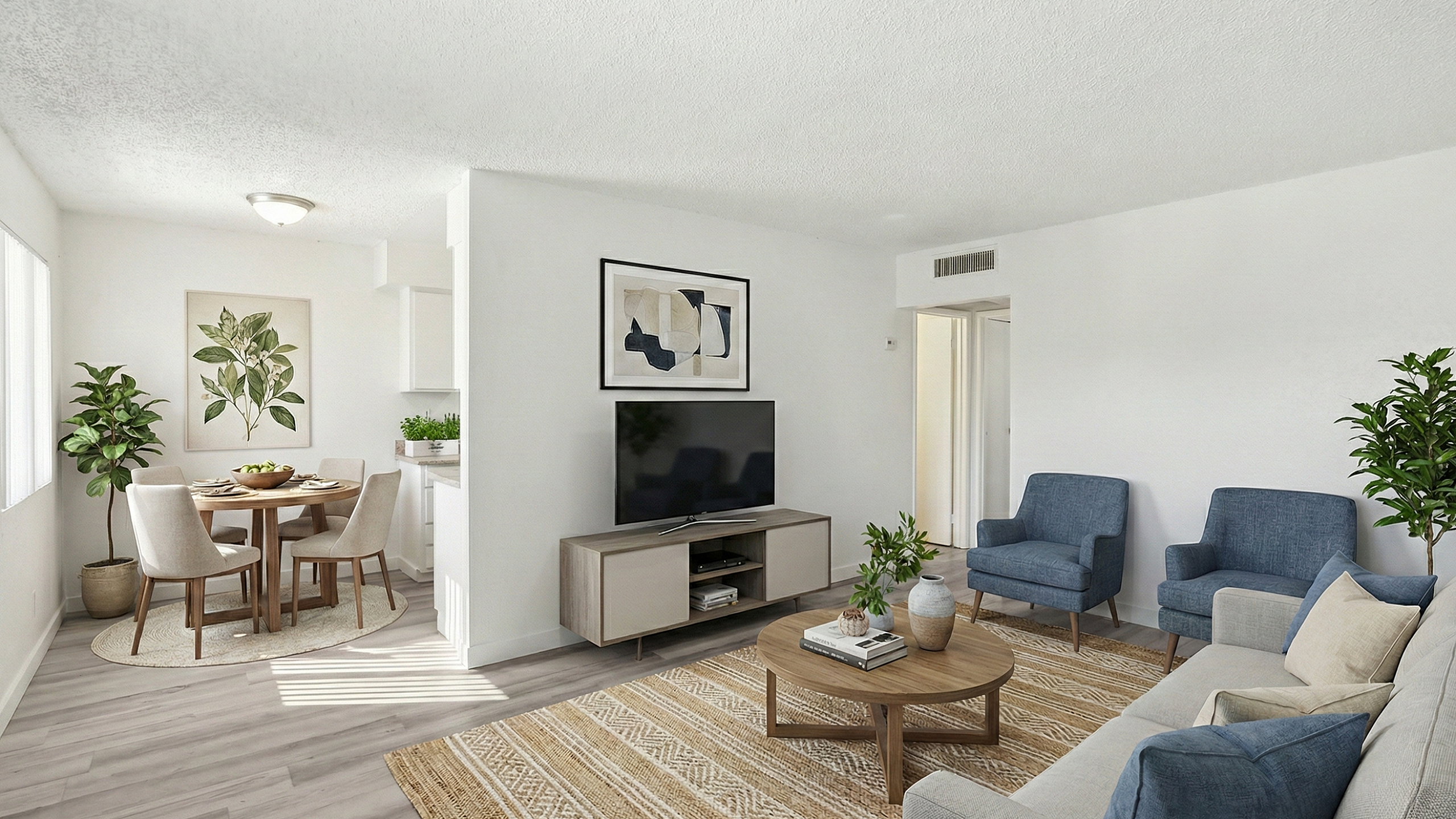 Bright and stylish living room with modern decor, featuring a cozy seating area, flat-screen TV, and dining nook with elegant chairs. Large windows fill the space with natural light, accentuating the contemporary artwork and lush green plan