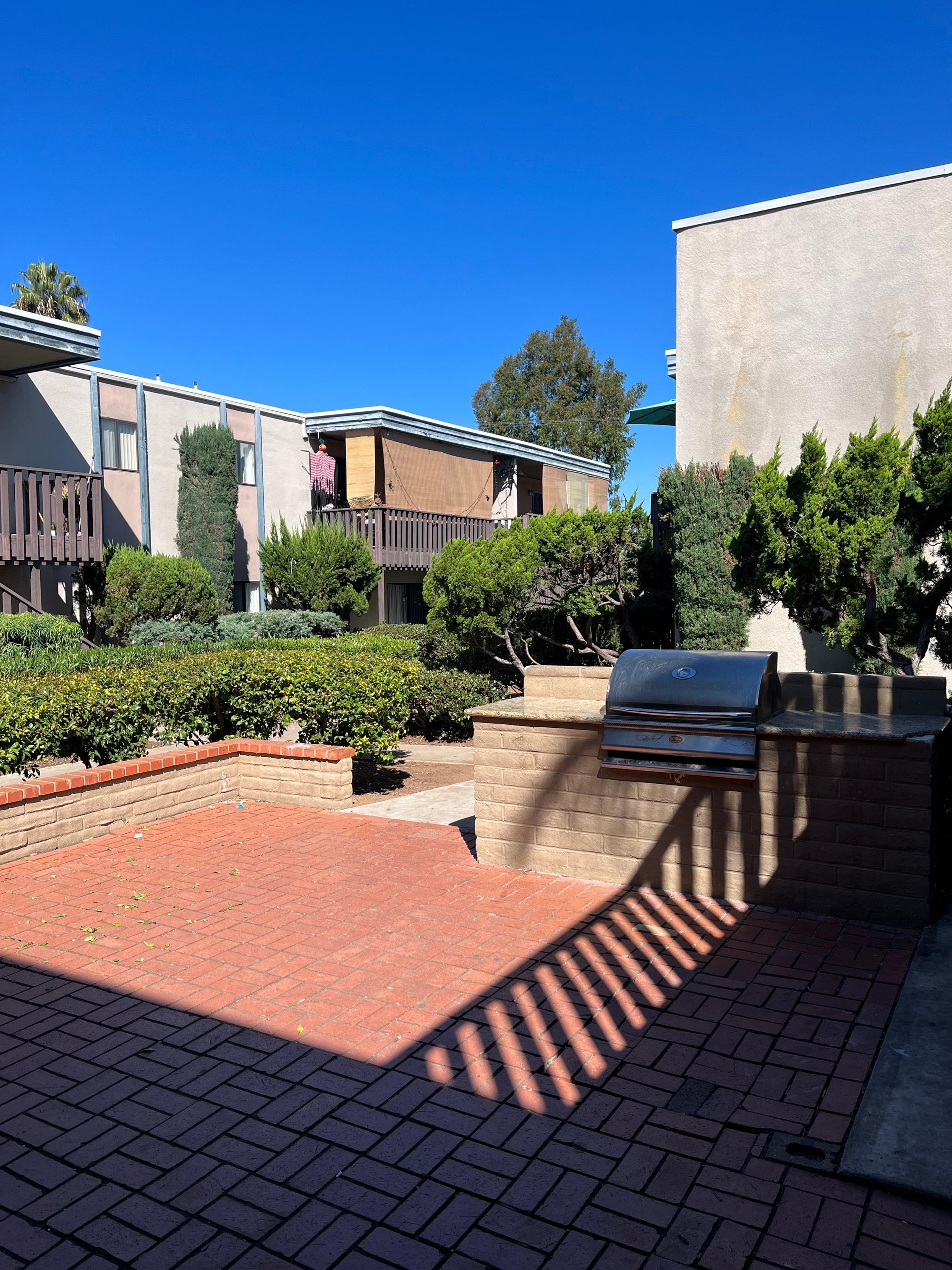gated pool area with bbq grilling area