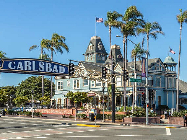 carlsbad sign with blue house in the back