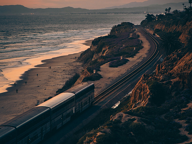 aerial of the coaster train traveling along the coast