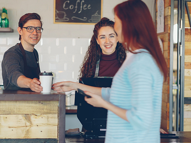 woman buying a coffee at a shop