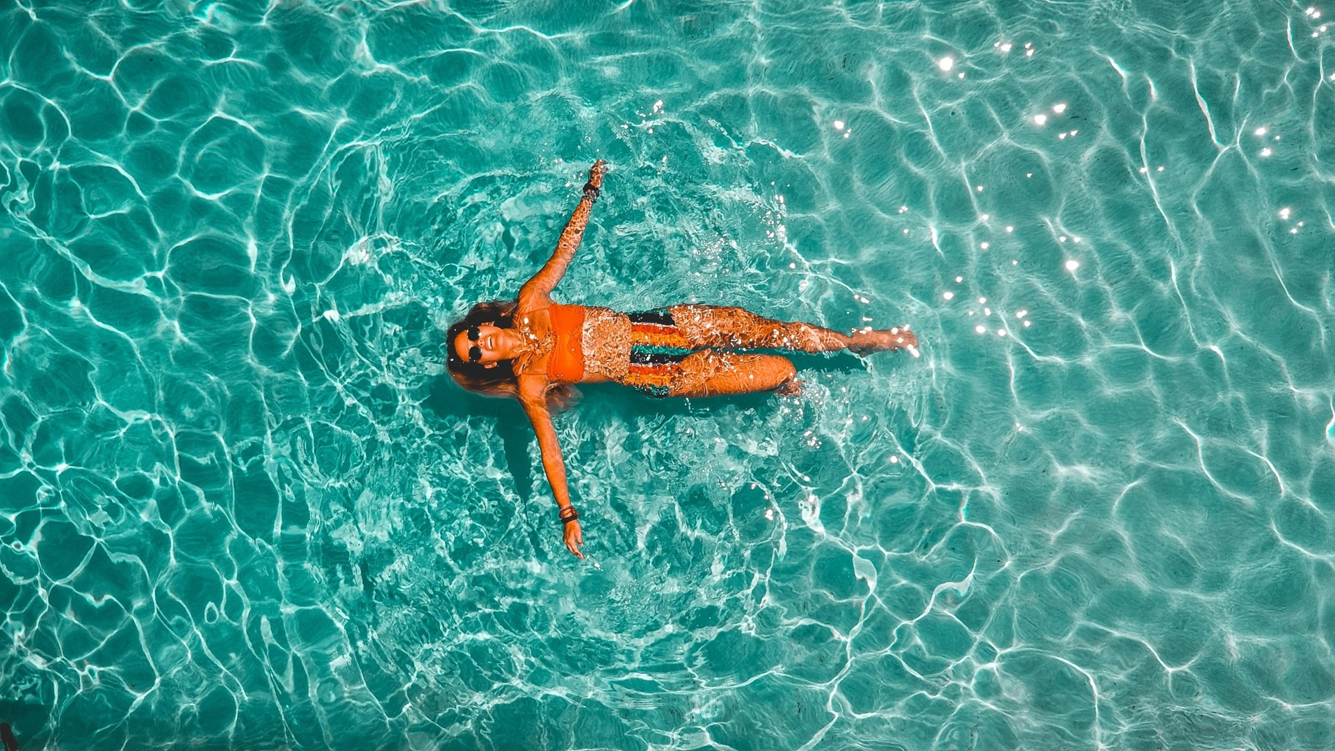 aerial shot of woman swimming in pool