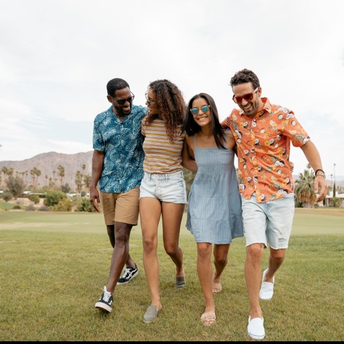 4 people walking while holding each other at the shoulders