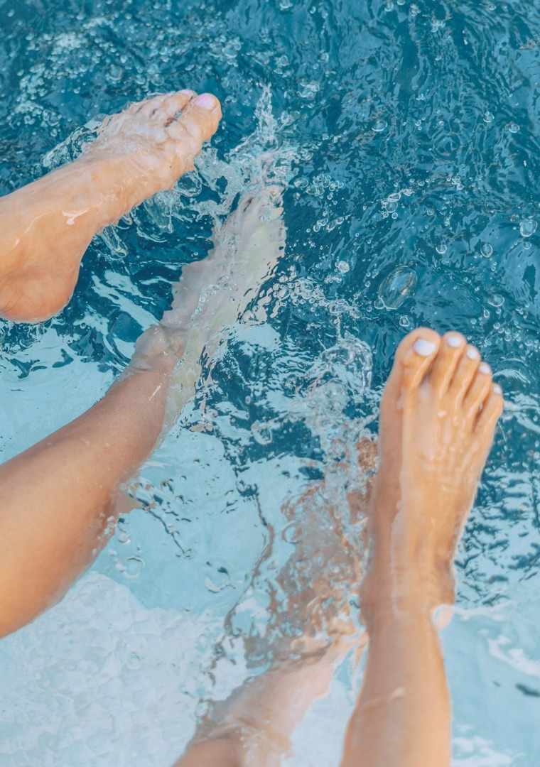 feet splashing in pool