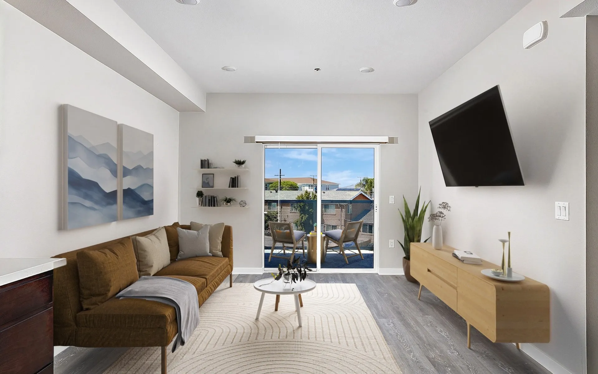 Virtually staged living room with luxury vinyl plank flooring and a balcony
