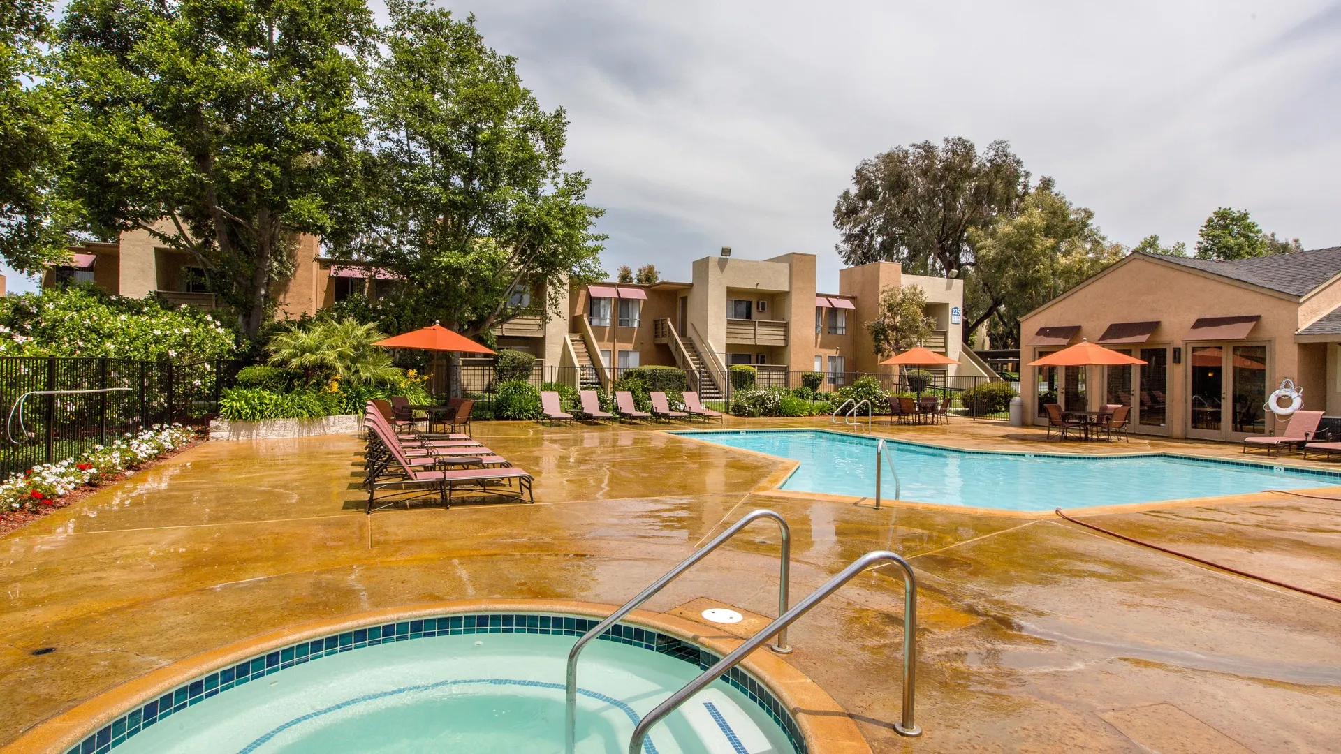 community pool and lounge area with spa