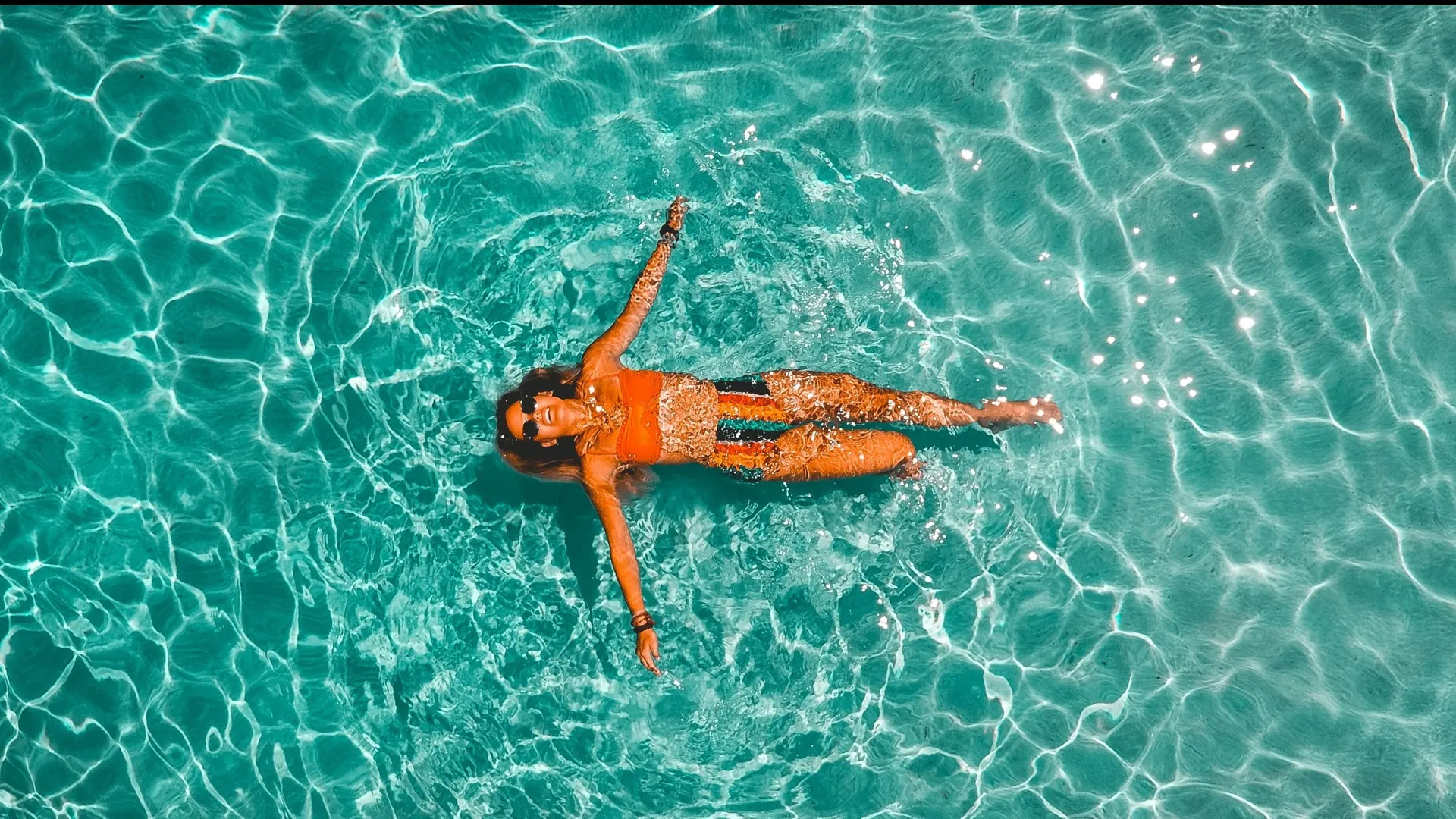 woman floating in pool