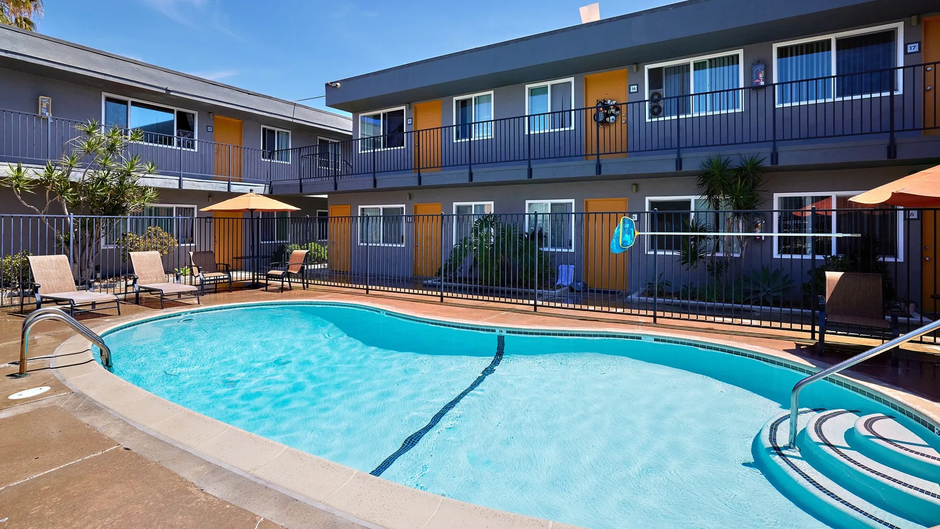 Elivia pool and lounge area with tropical landscaping