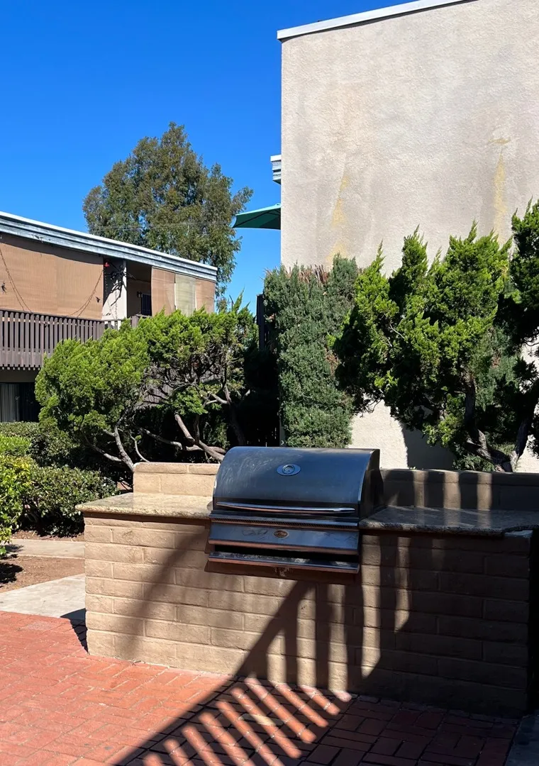gated pool area with bbq grilling area