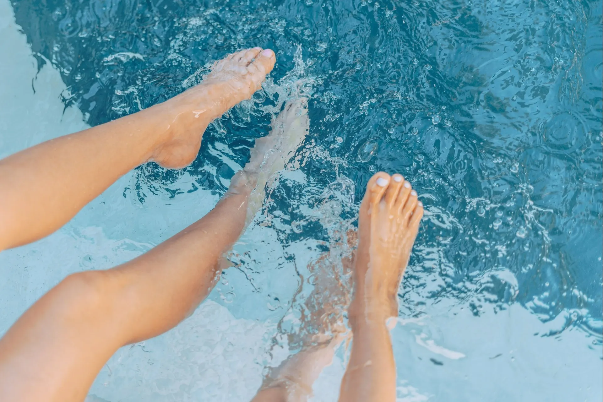 Feet splashing in pool