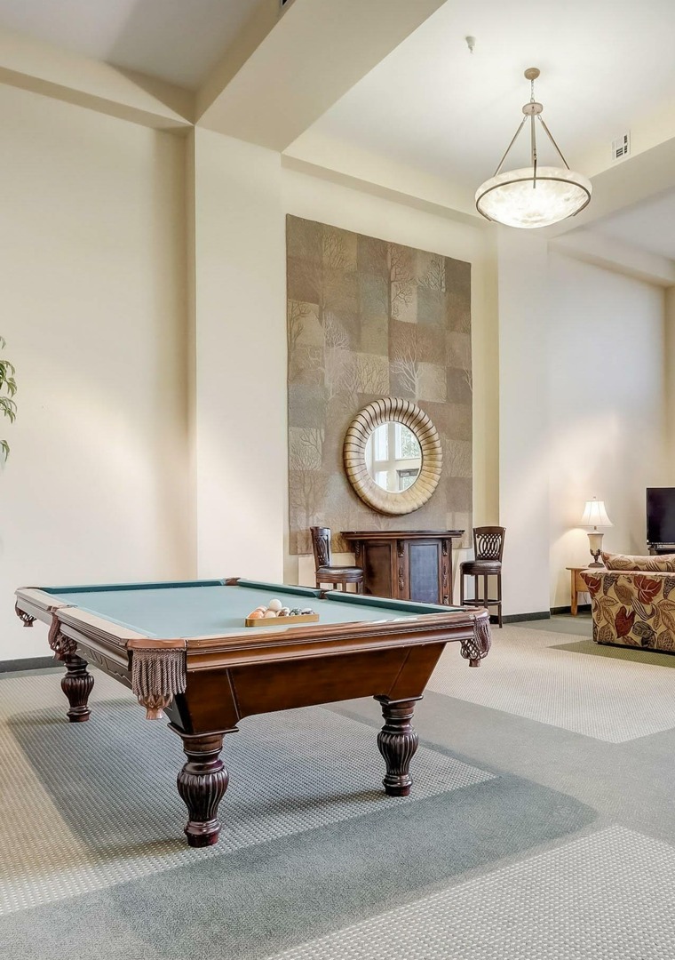 Billiards table and lounge area in clubhouse