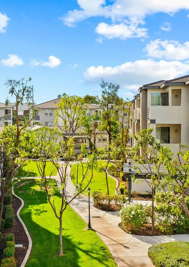 third story view of walkway with well maintained green areas