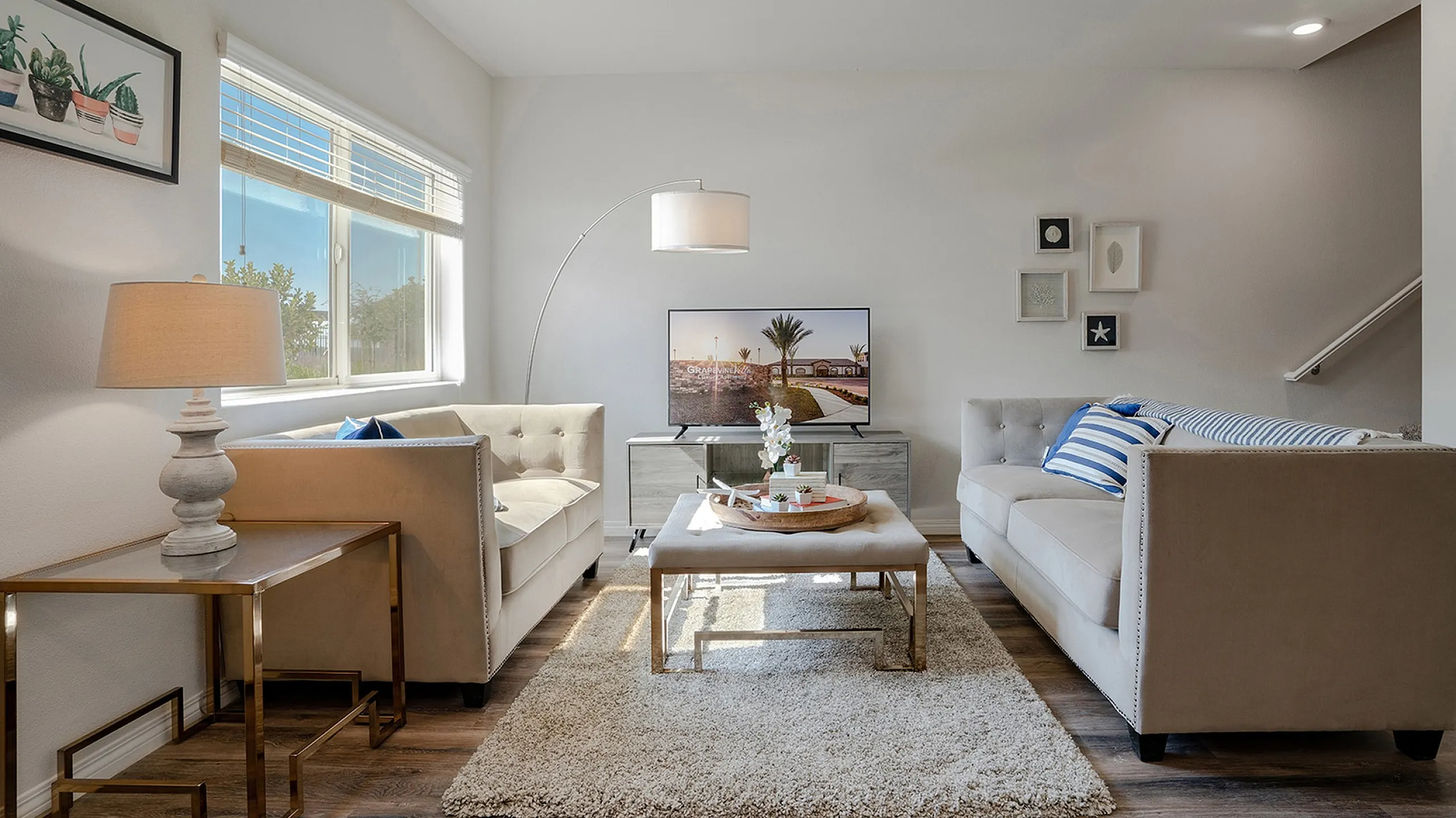 living room with taupe sofas, decorative rug and glass coffee table at Grapevine Villa