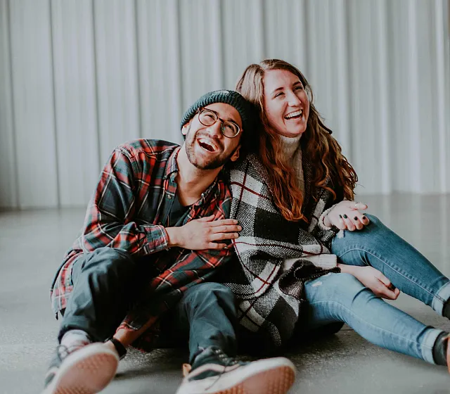 two-people-sitting-on-the-floor-having-a-good-time