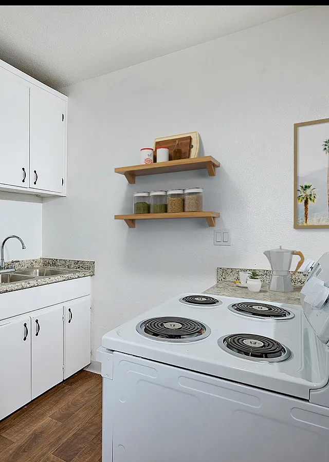 Kitchen with refrigerator, sink, and stove