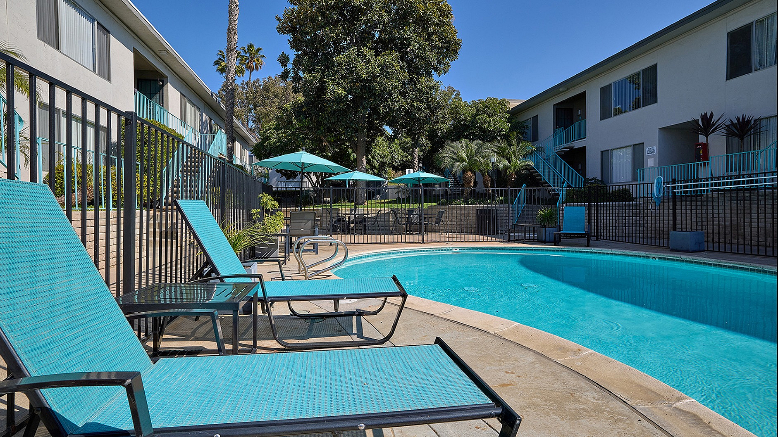 Pool area with lounge seating and picnic tables