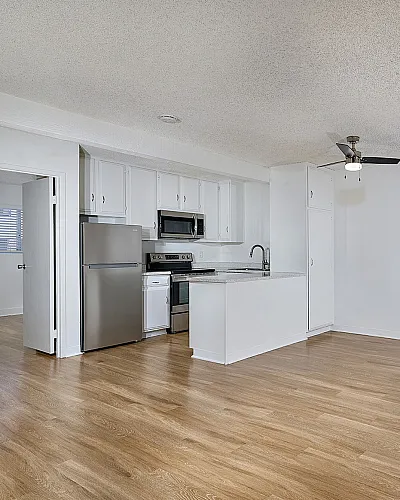 living room and kitchen with vinyl plank wood flooring and large window
