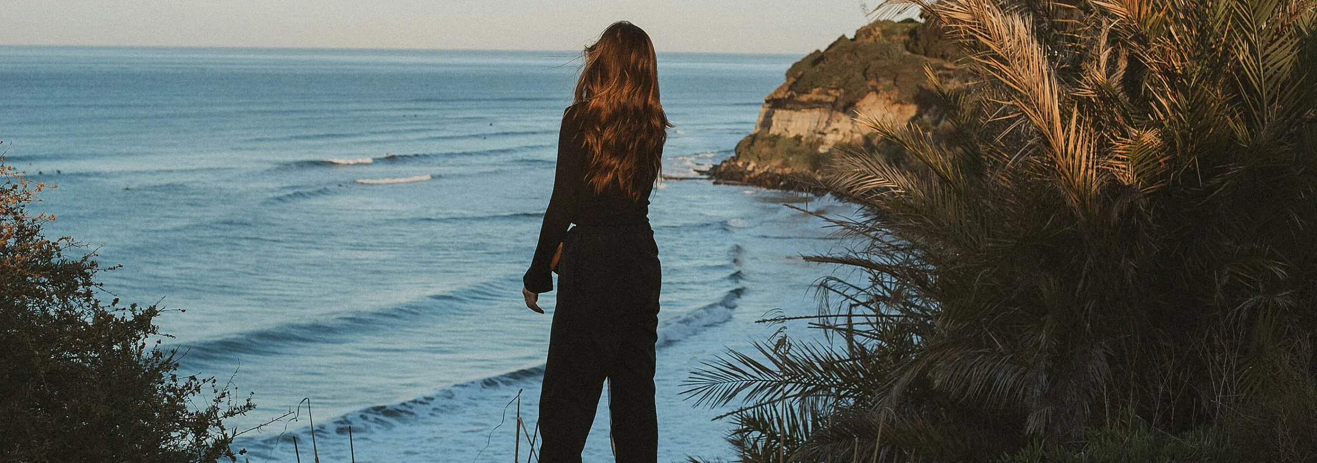 woman looking out at the beach