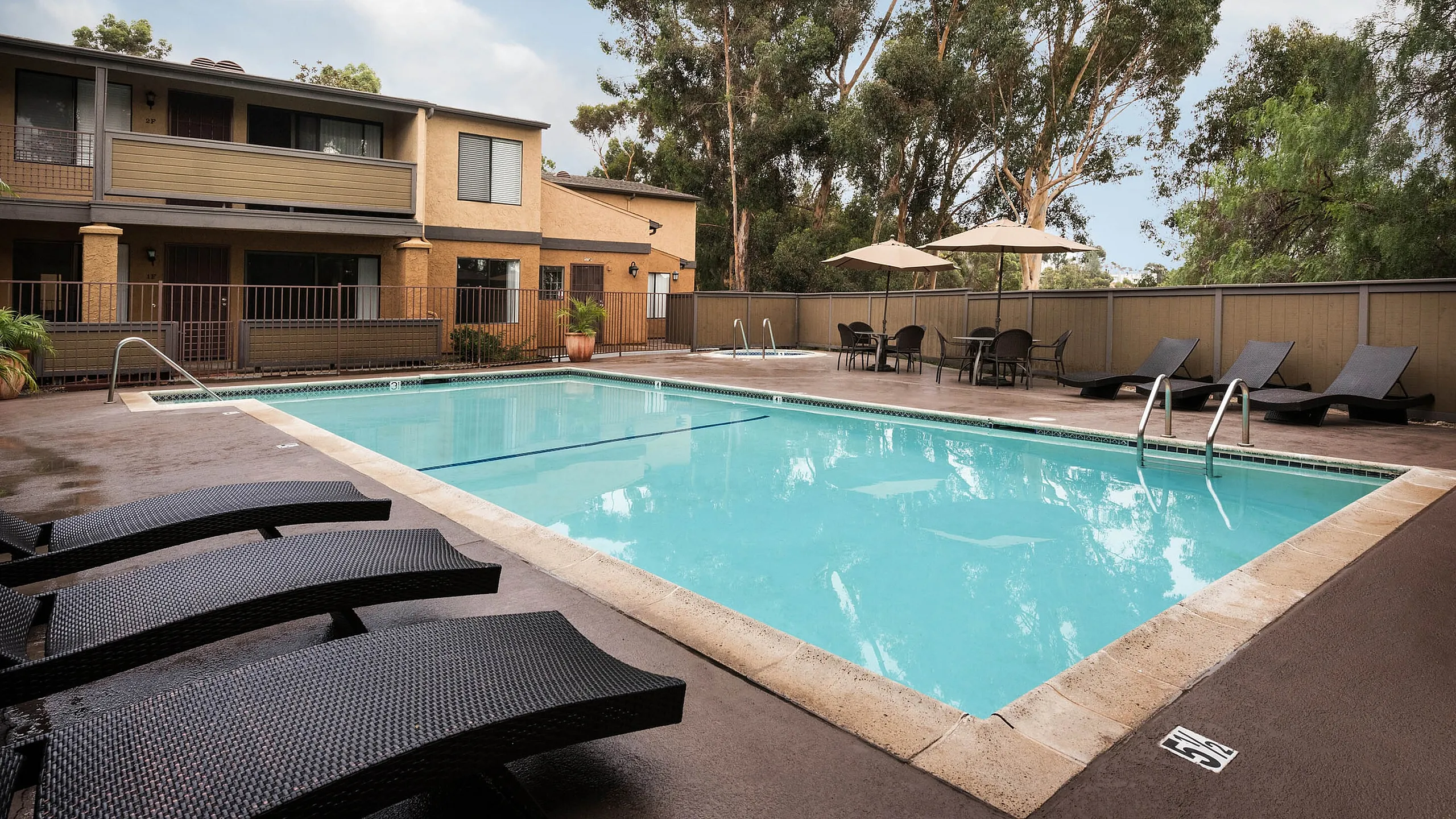 Refreshing swimming pool with lounge chairs at Elan - Scripps Terrace.