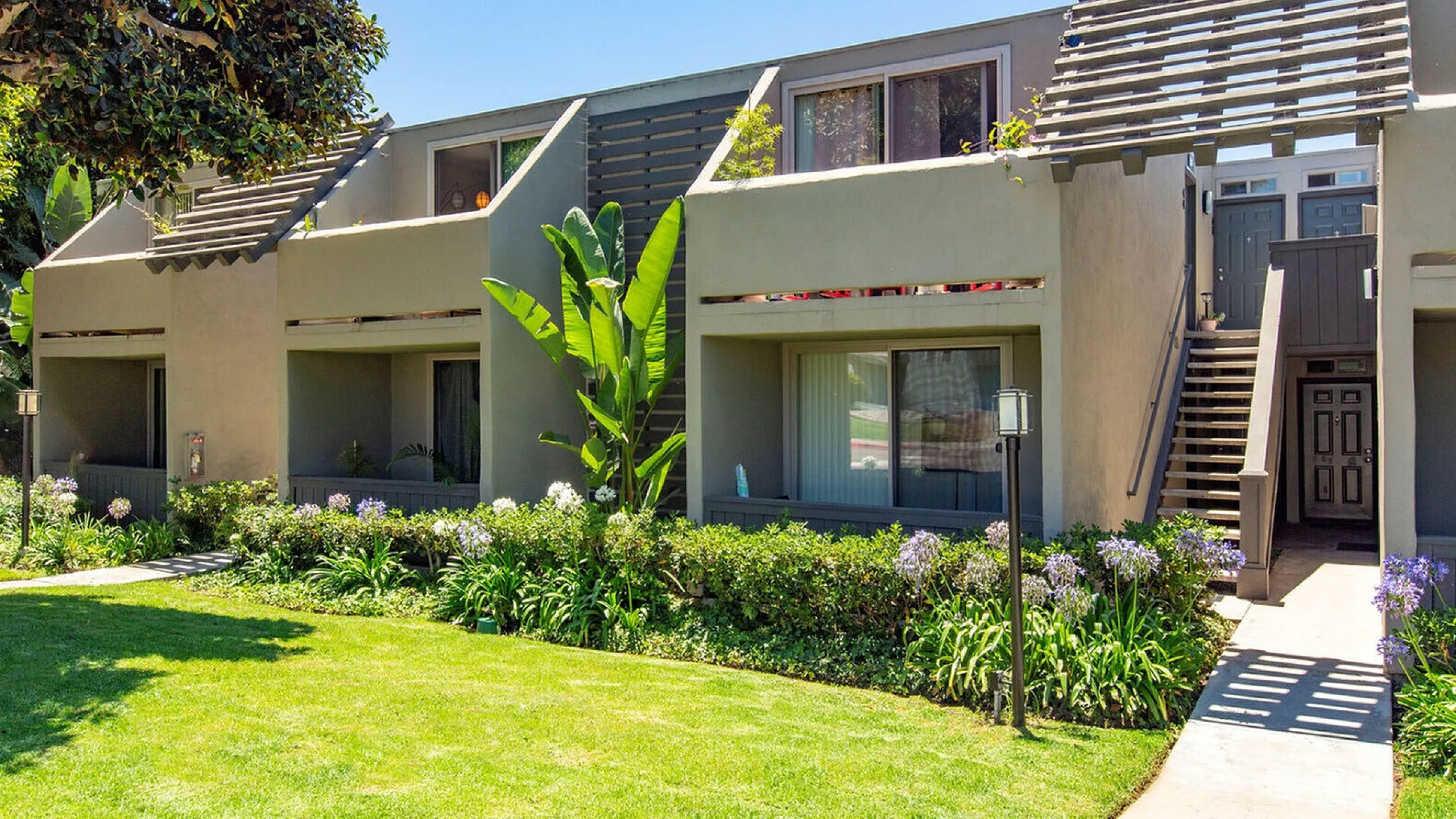 Coastal building with blooming bougainvillea and balconies at Elan - Sandpiper Del Mar