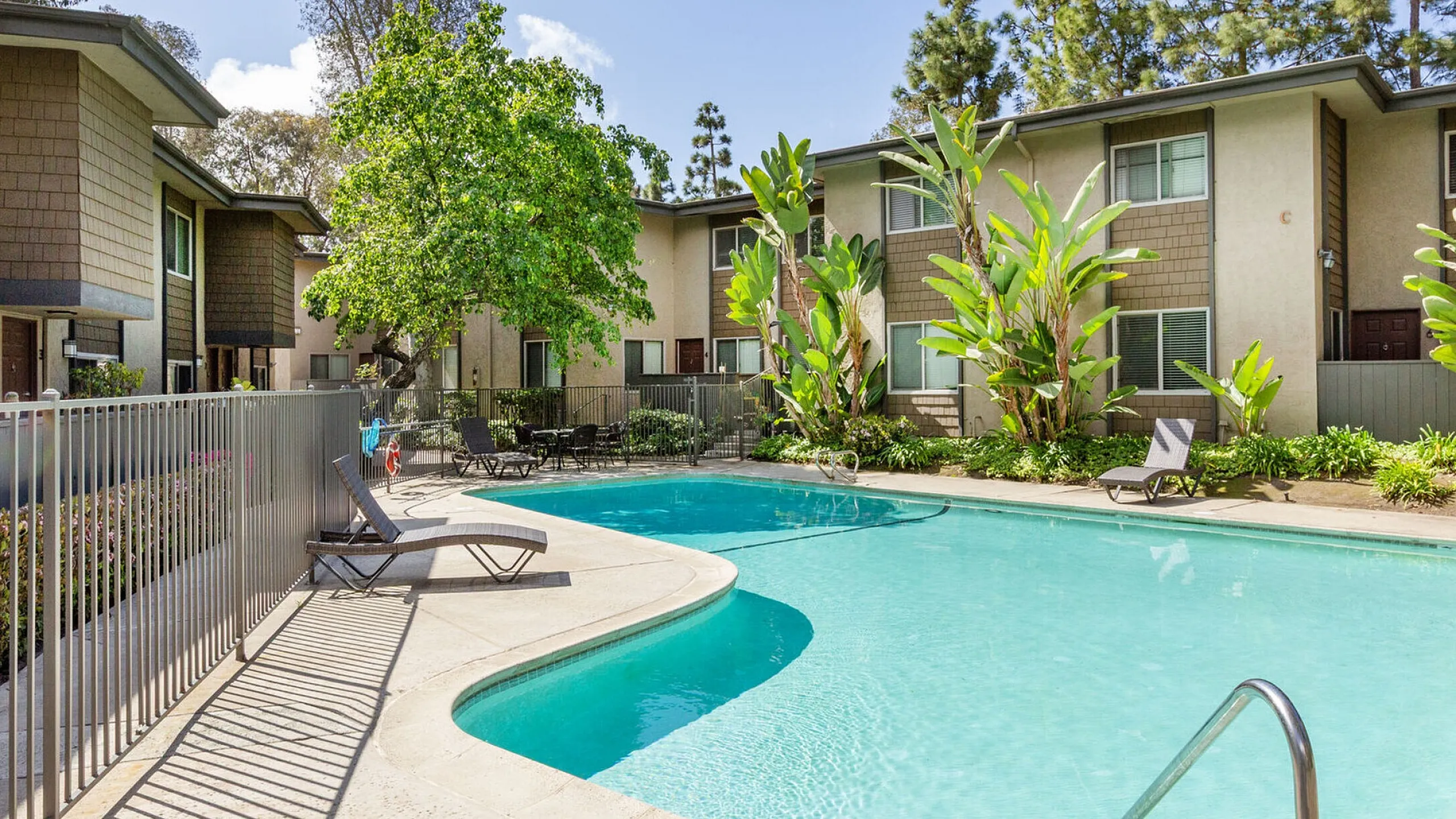 Sparkling swimming pool and sun deck with lounge chairs at Elan - Solana Pointe.