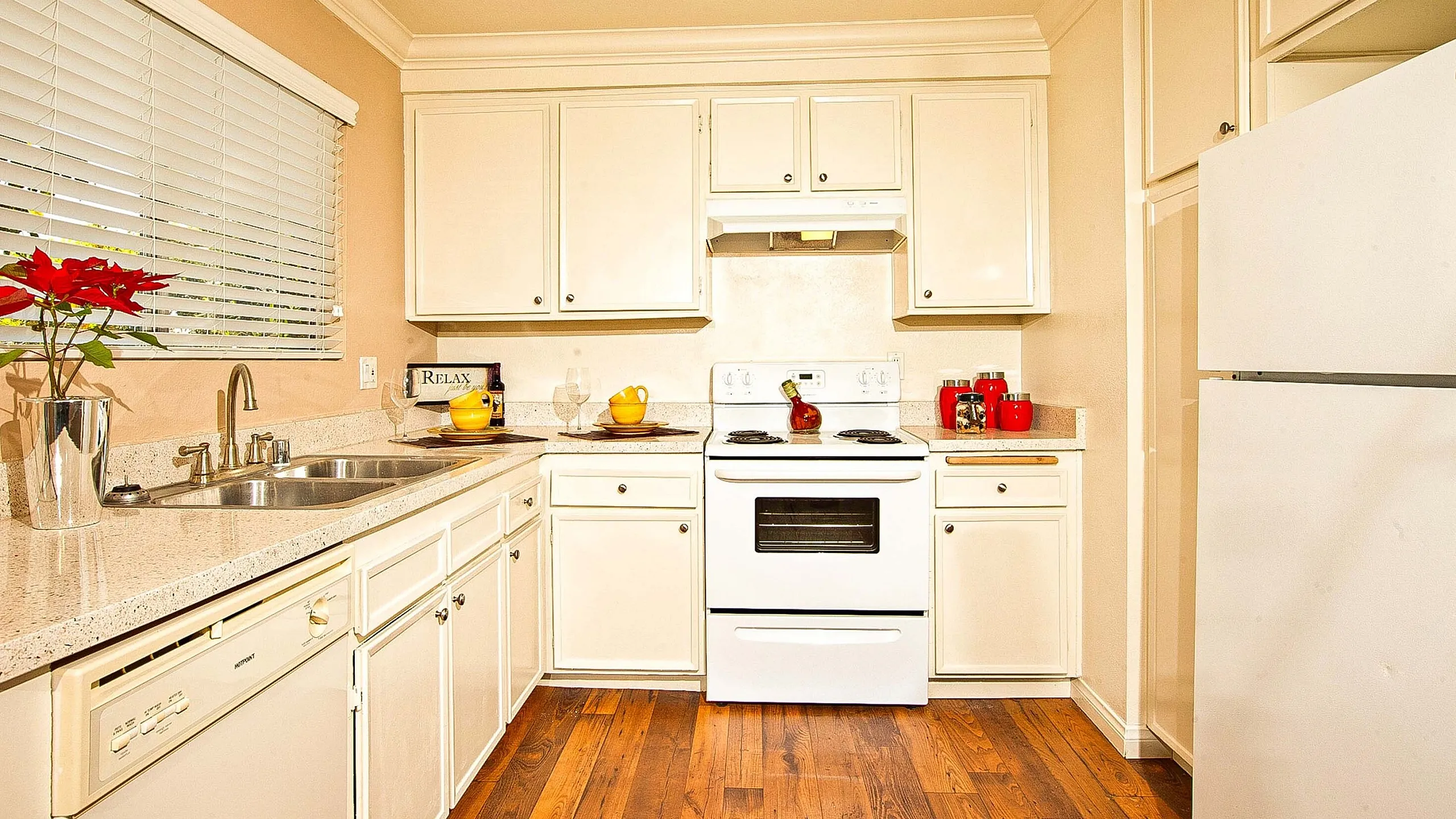 Bright kitchen featuring white cabinetry and window at Elan - Solana Pointe.
