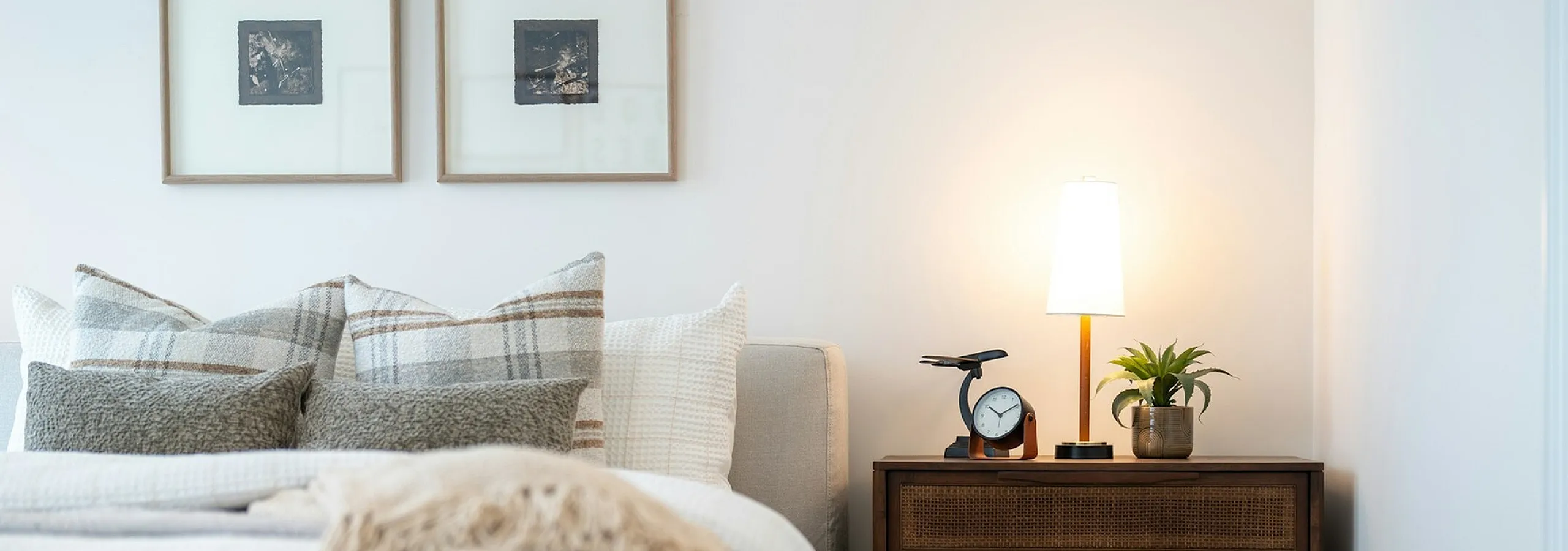 bed with decorative pillows and side table with lamp
