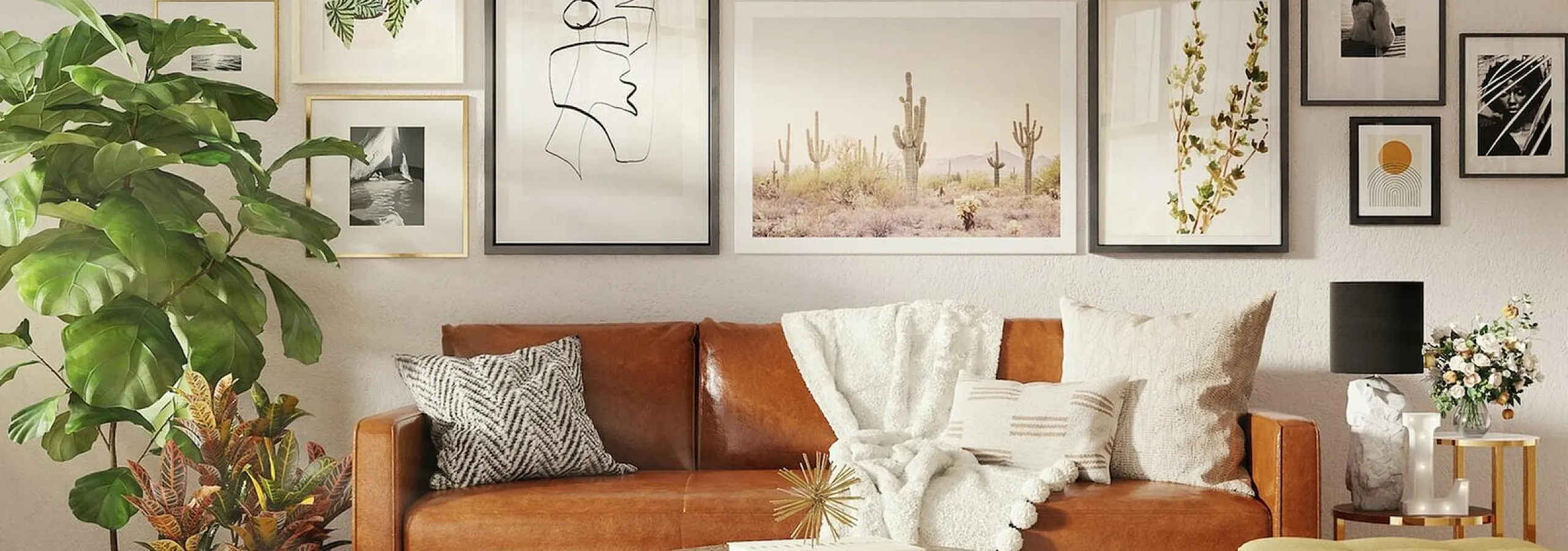 brown leather sofa with many art frames hanging behind