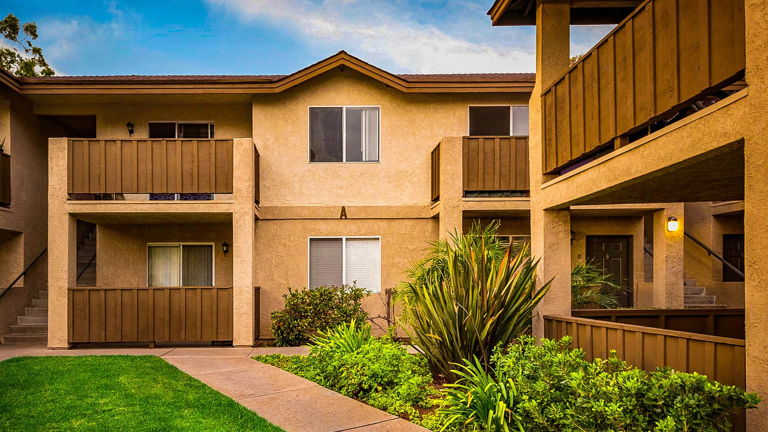 Apartment building exterior with private balconies and patios at Elan - poway hills.